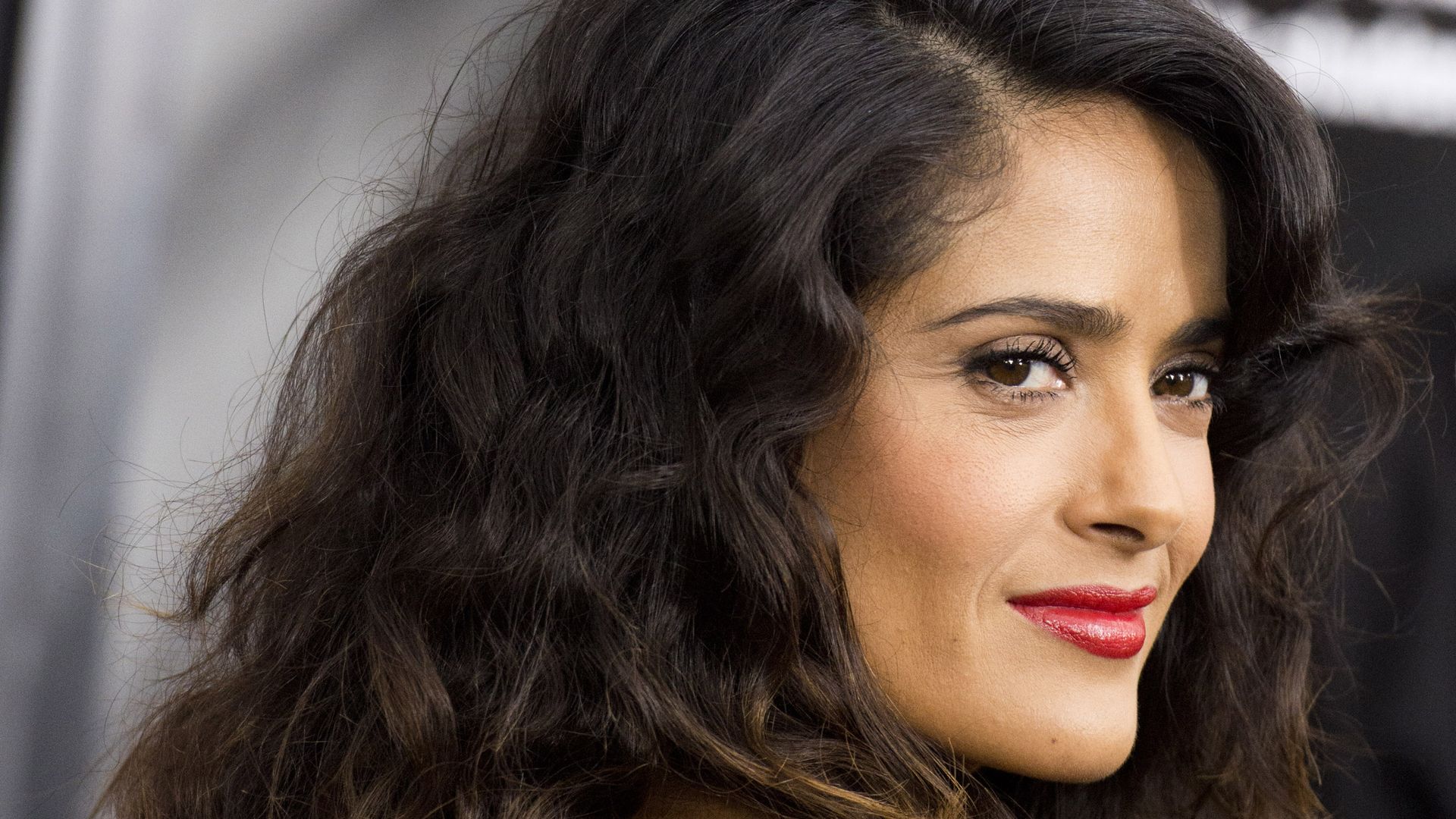 Mexican-American actress Salma Hayek looks over her shoulder.