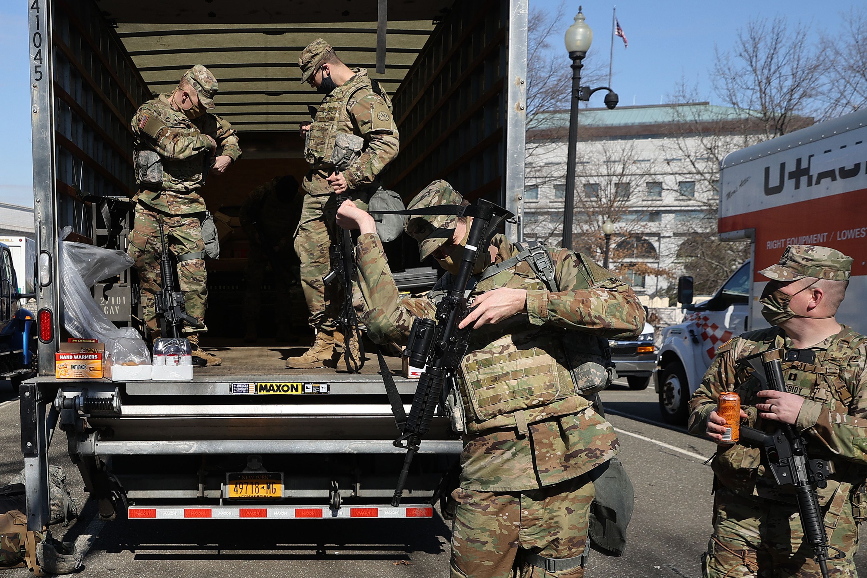 National Guard members collect their weapons on Monday. Photo: Chip Somodevilla/Getty Images