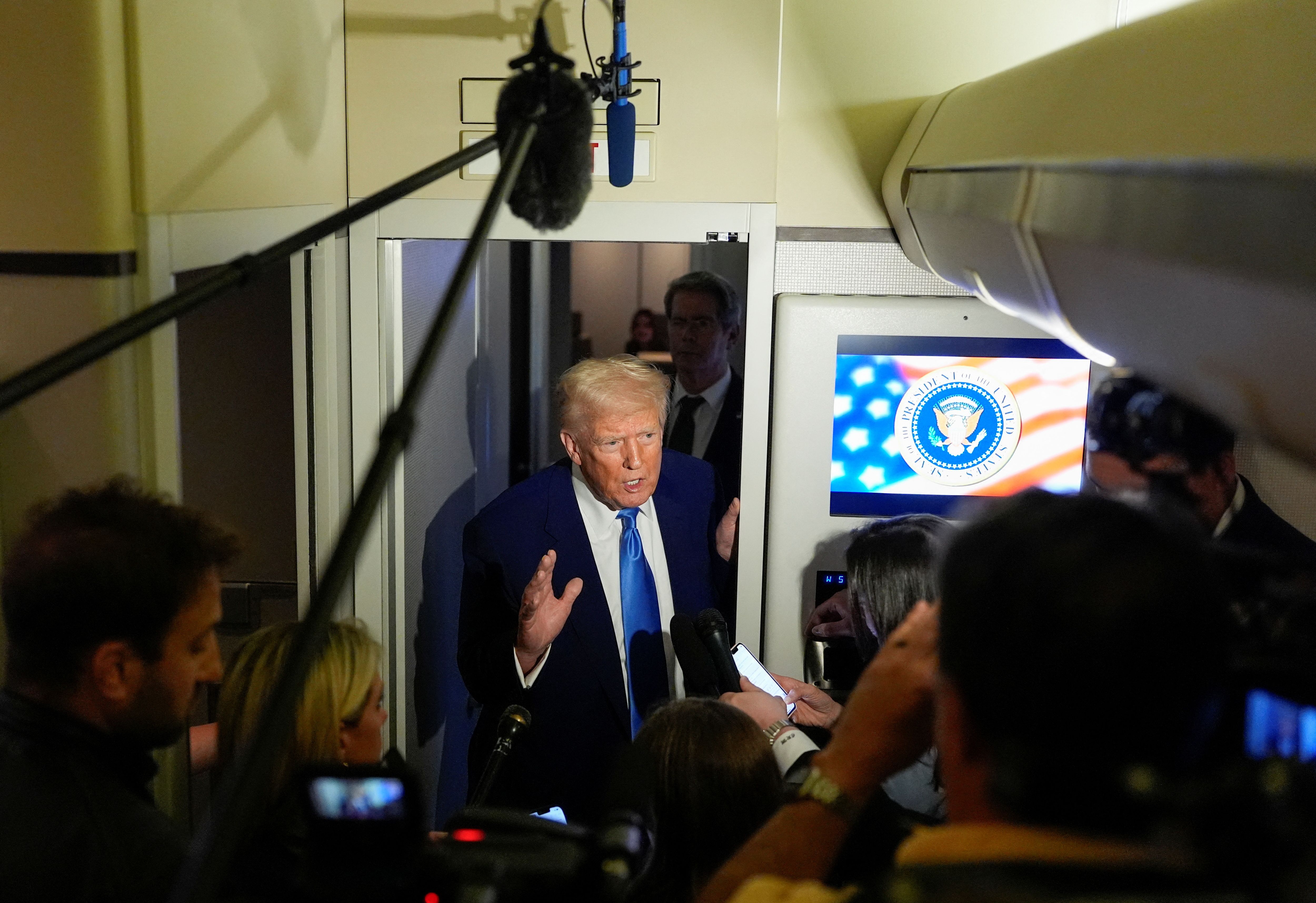 U.S. President Donald Trump talks to members of the press aboard Air Force One during a flight to Joint Base Andrews, Maryland, U.S., April 6, 2025. REUTERS/Kent Nishimura