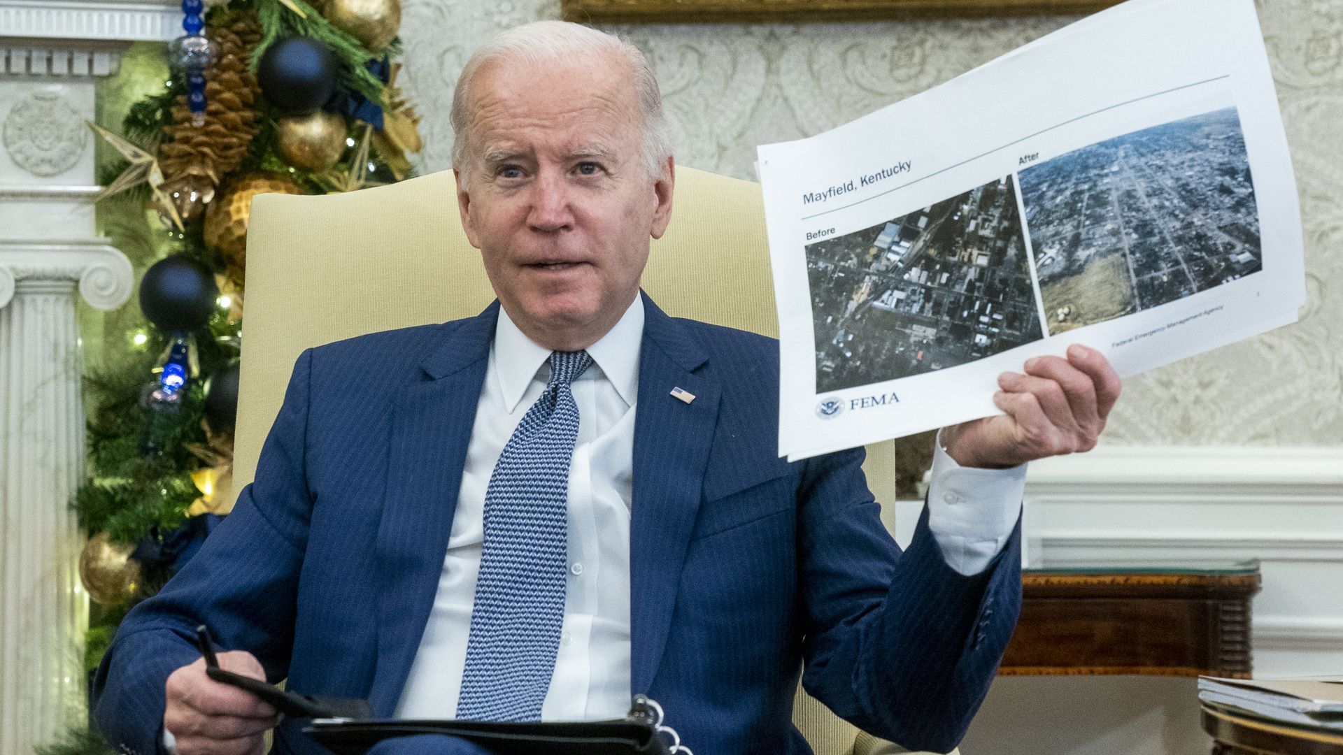President Biden is seen holding up before and after photos of tornado-stricken Mayfield, Kentucky.