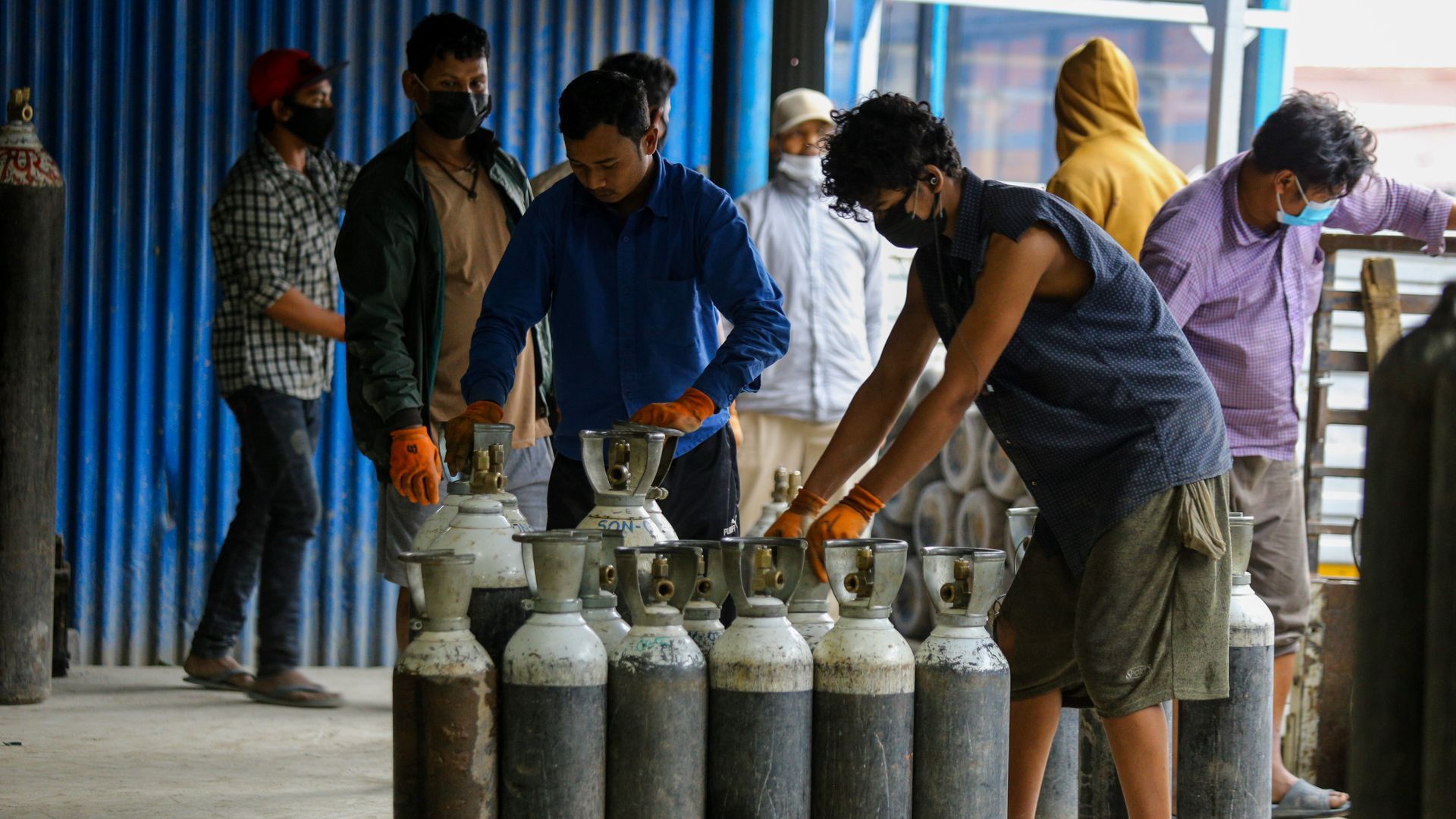 Workers upload oxygen cylinders at a hospital in Lalitpur, Nepal in May 2021.