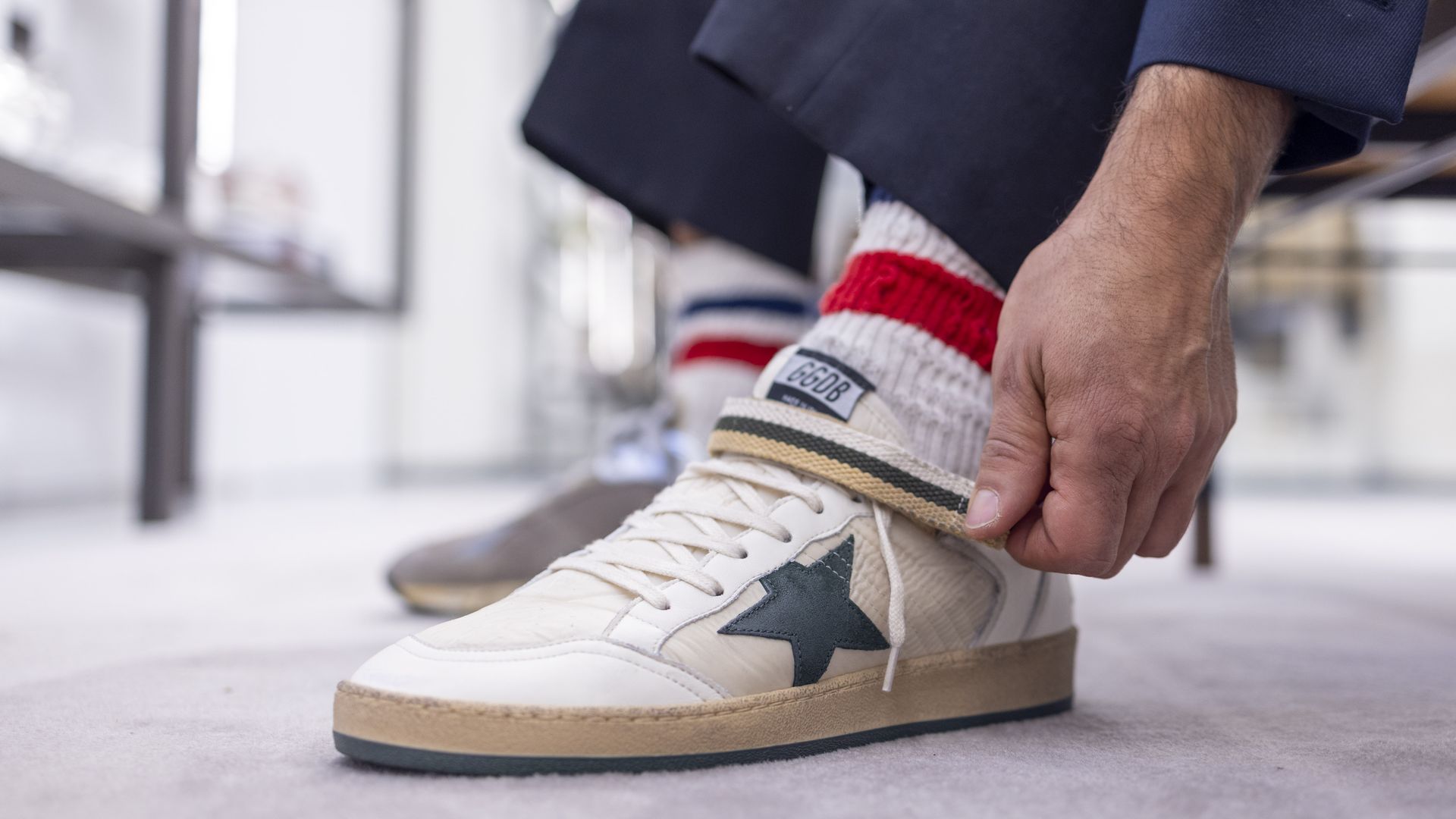 A person tries on a pair of sneakers