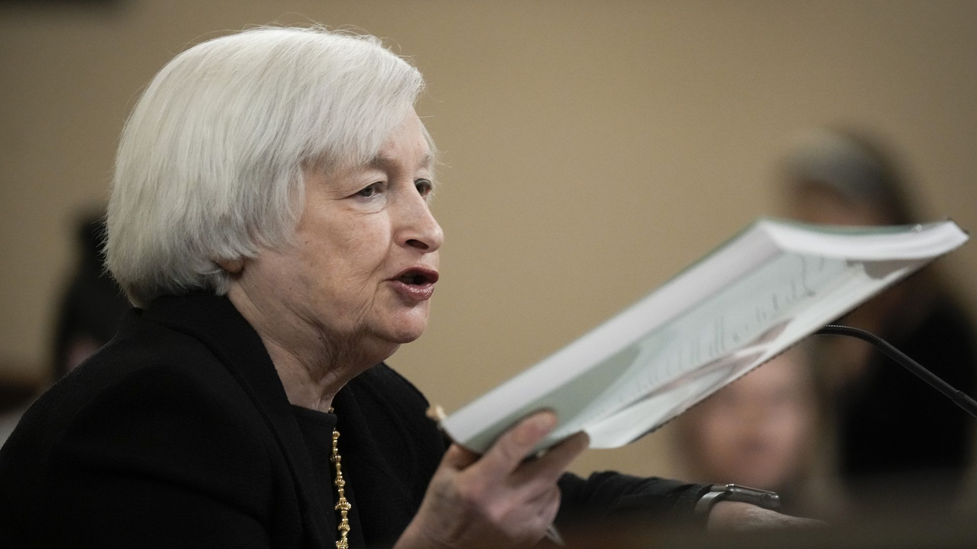 anet Yellen holds up a copy of the Treasury Departments Greenbook