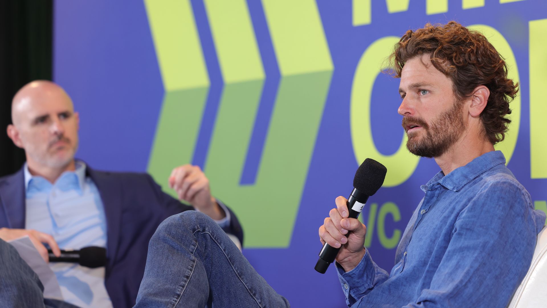 Steuart Walton talks to a group of venture capitalists from a stage. 