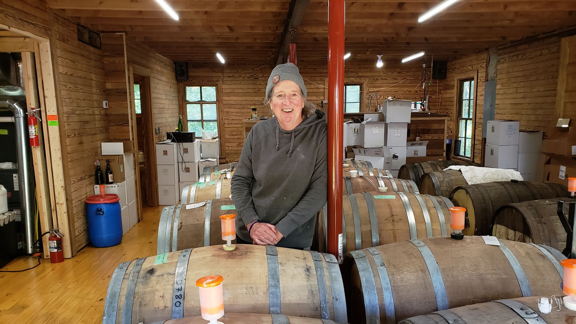 Woman standing amid wind barrels 