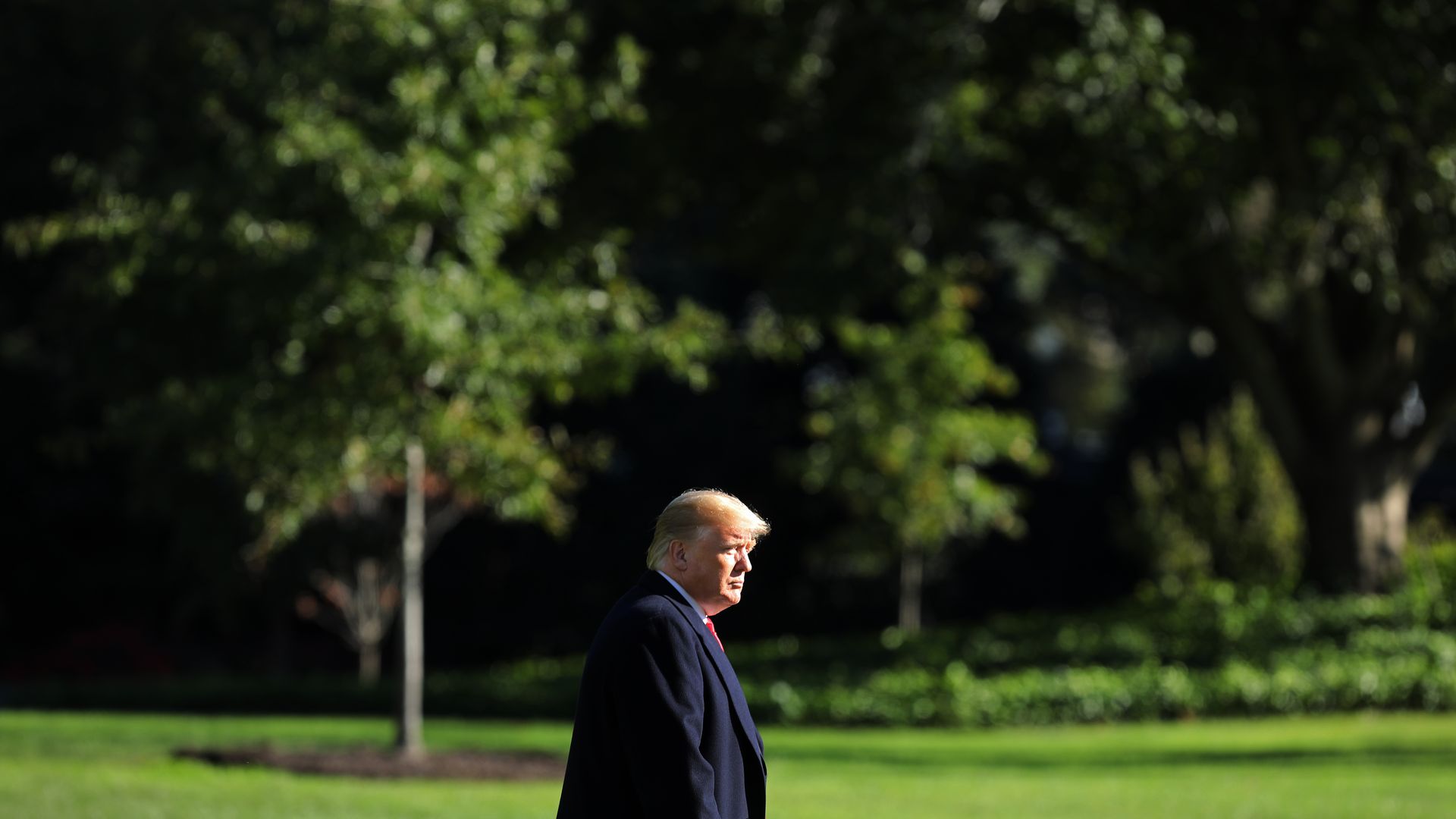 President Trump walking across the South Lawn.