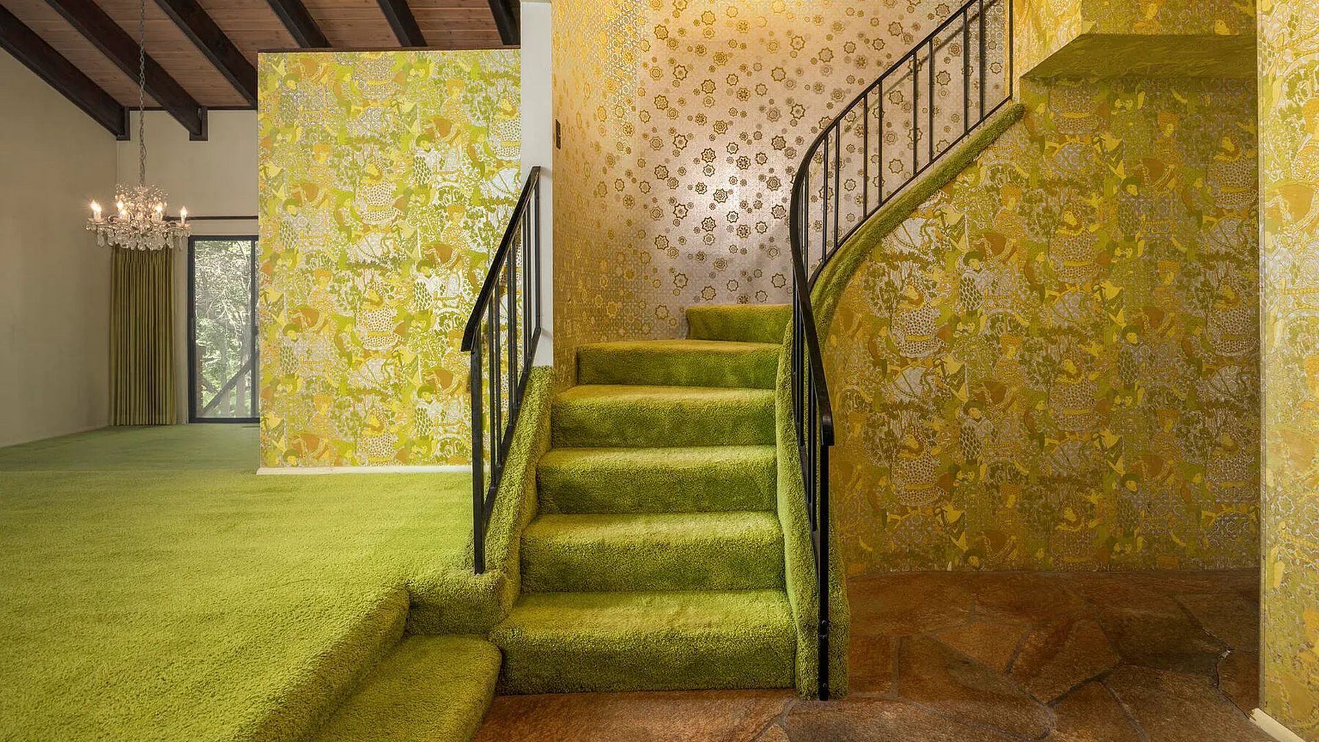 A 70s home with green carpet and metallic wallpaper.