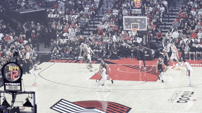 Animated gif of a professional basketball game. Damian Lillard receives a pass and shoots a three pointer.