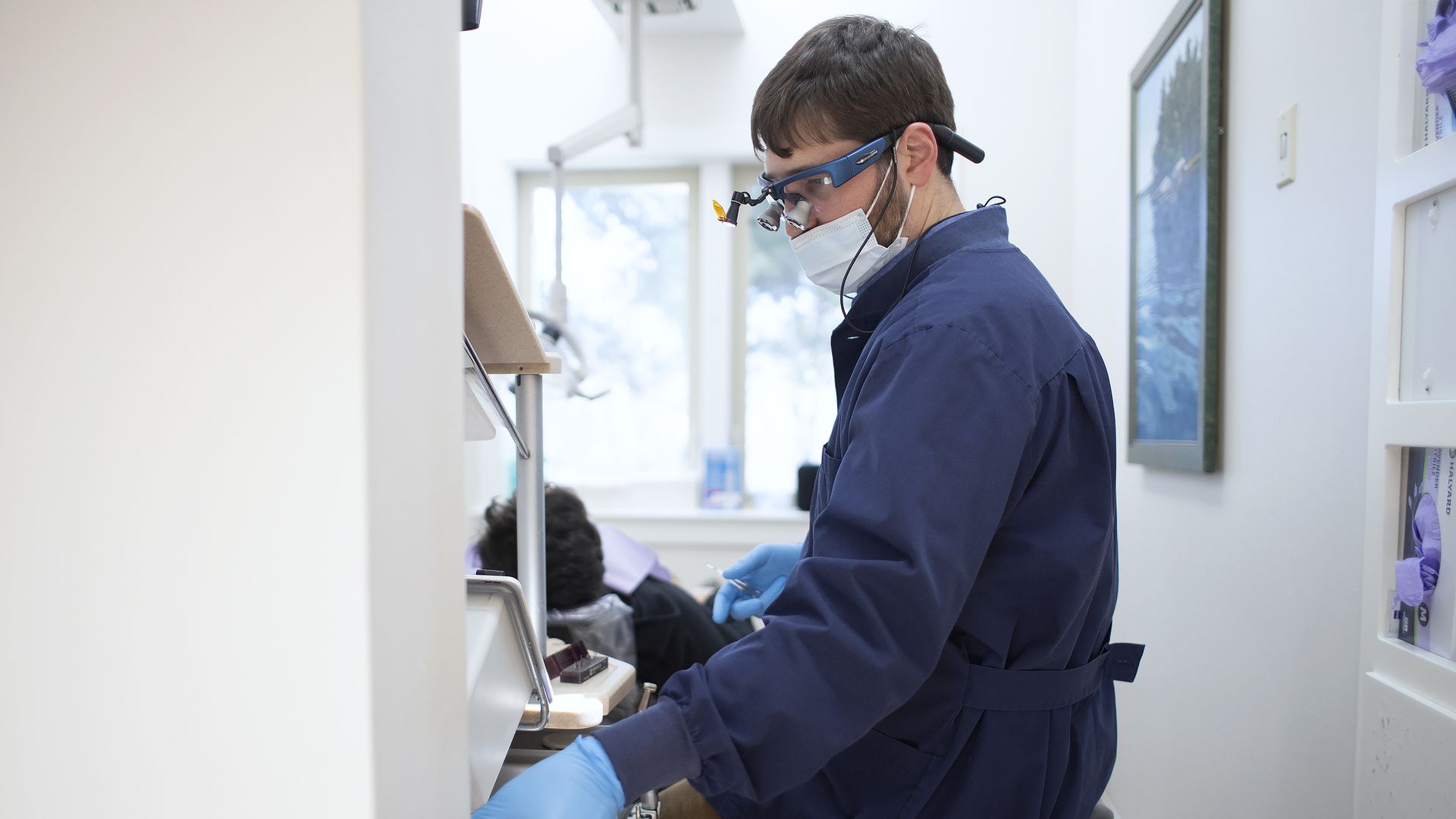 A dentist in Maine wearing a mask.