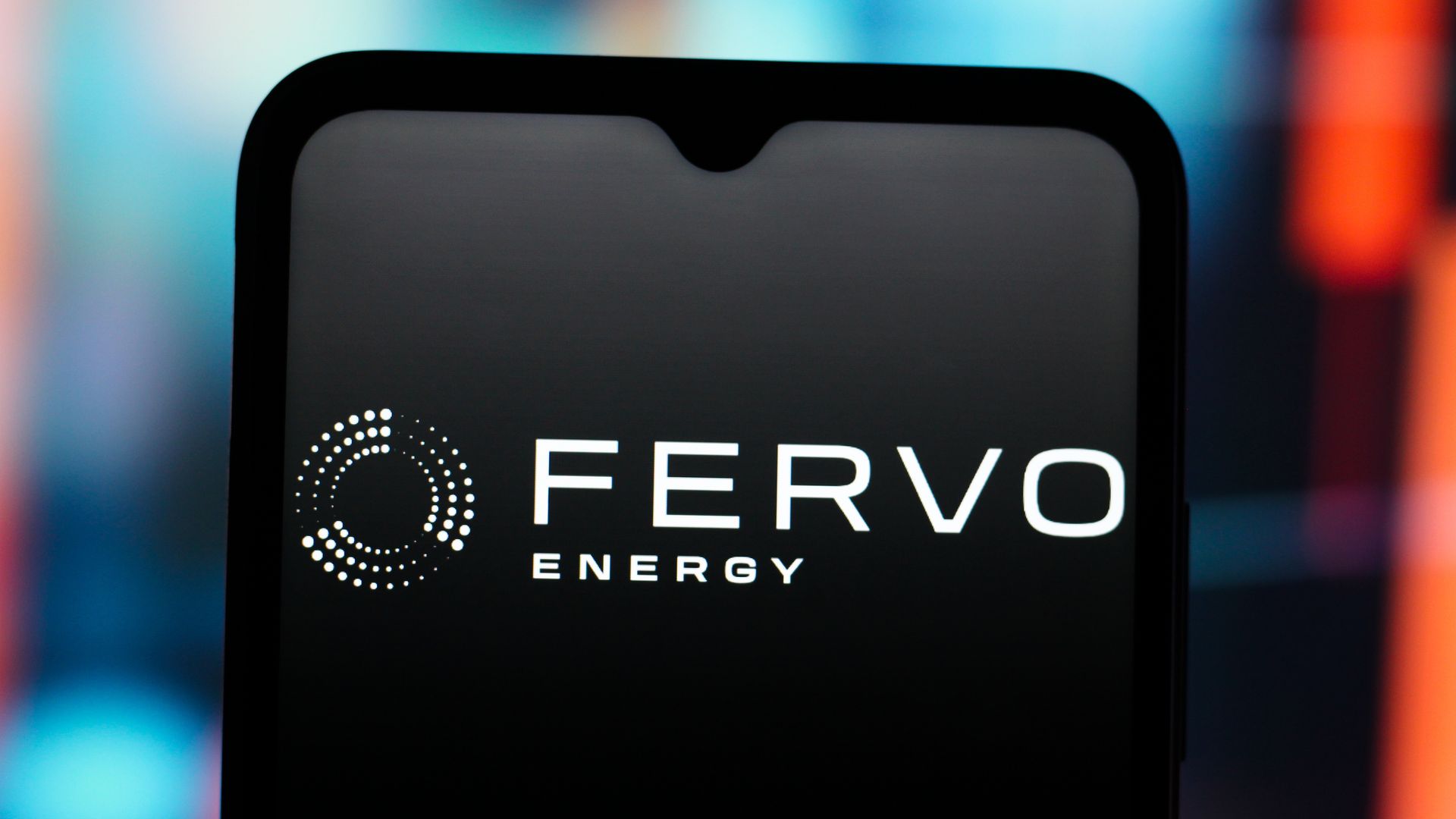 A white Fervo Energy logo is displayed on a darkened smartphone screen.