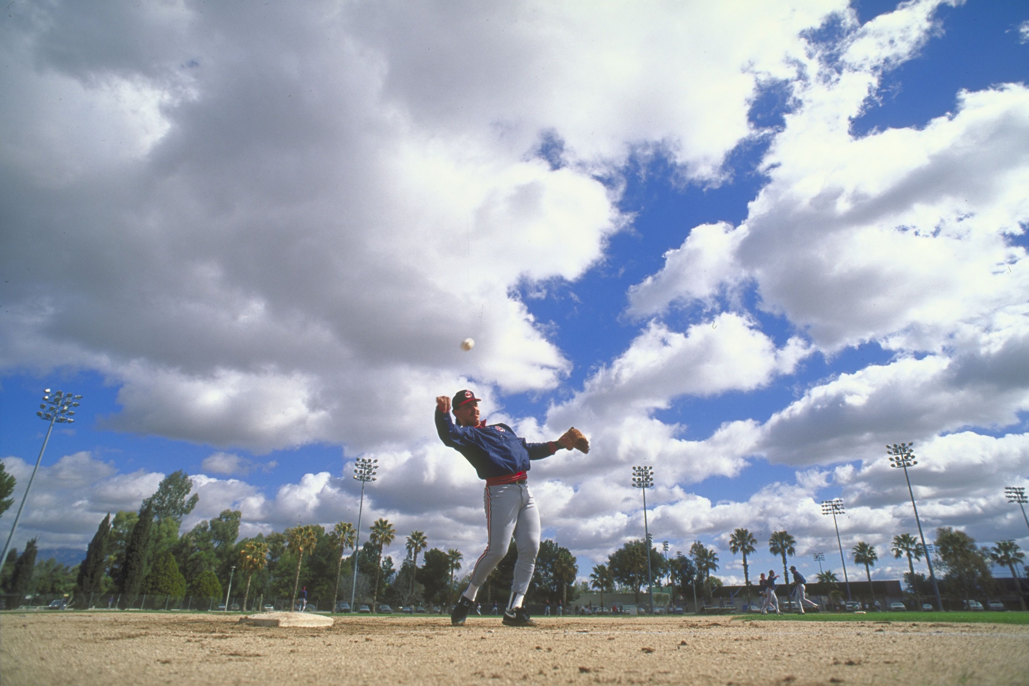 Cleveland pitcher Felix Fermin throwing the ball with a scenic Arizona backdrop.