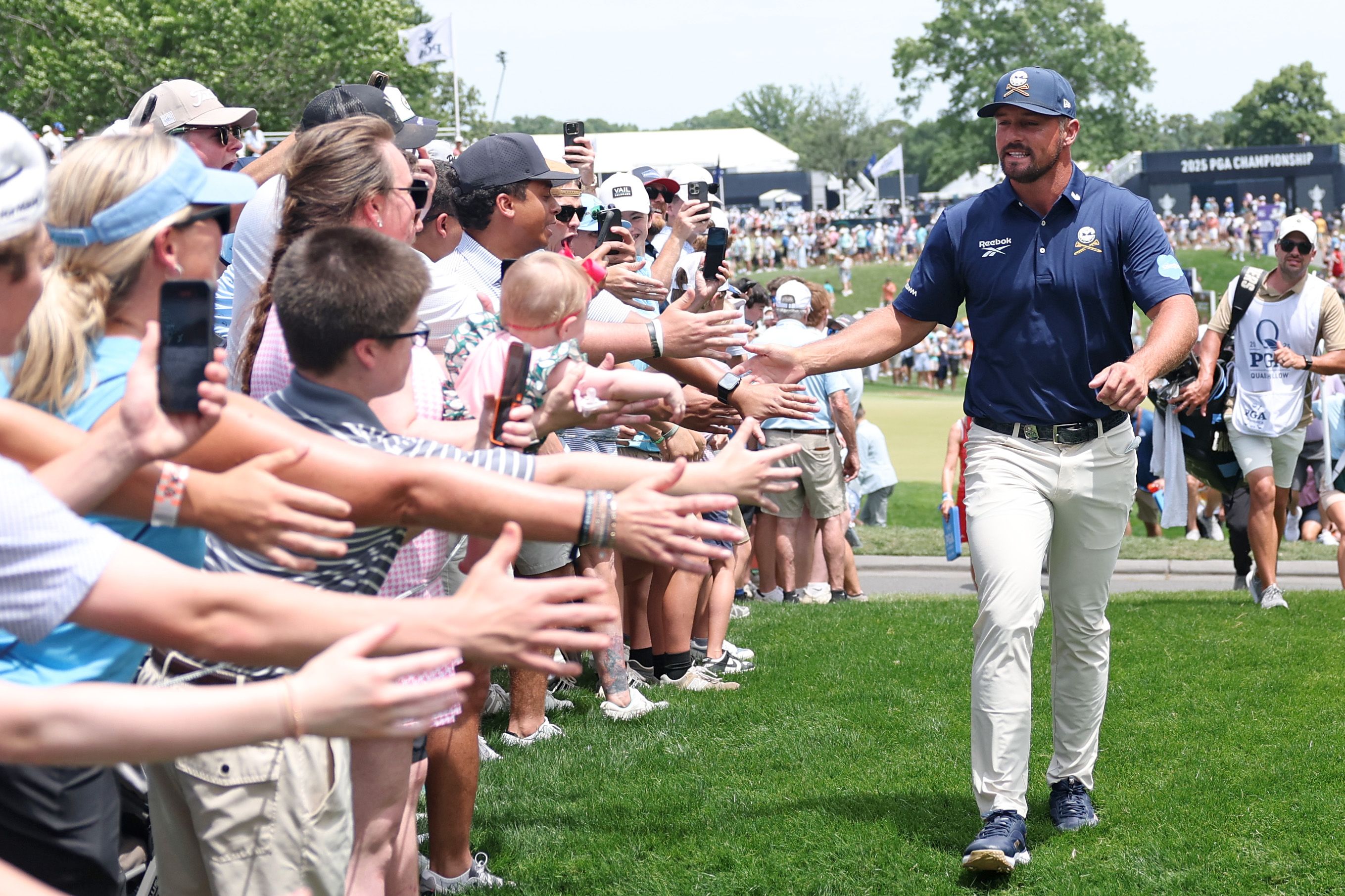 Bryson DeChambeau of the United States interacts with fans as he walks to the third tee during the final round of the PGA Championship at Quail Hollow Country Club on May 18, 2025 in Charlotte, North Carolina. (Photo by Warren Little/Getty Images)