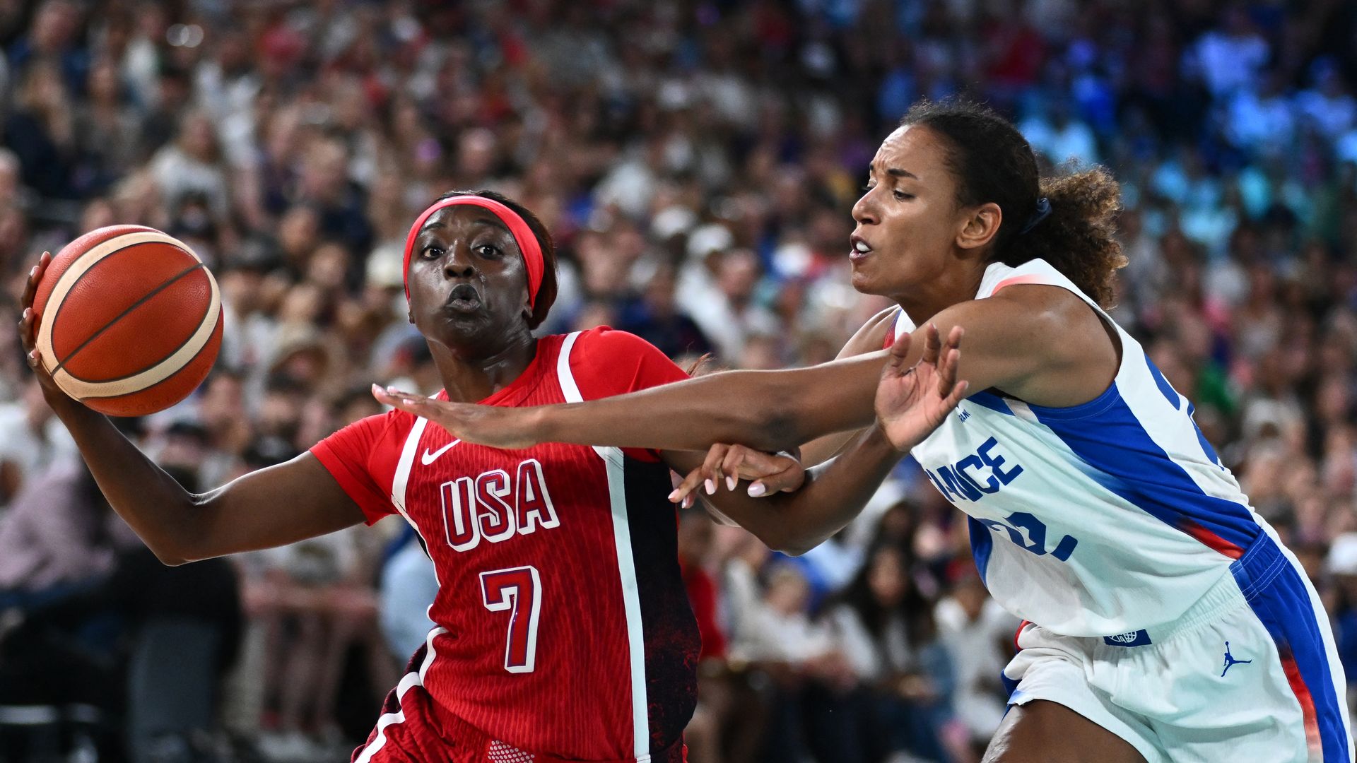 Two basketball players on the court. 