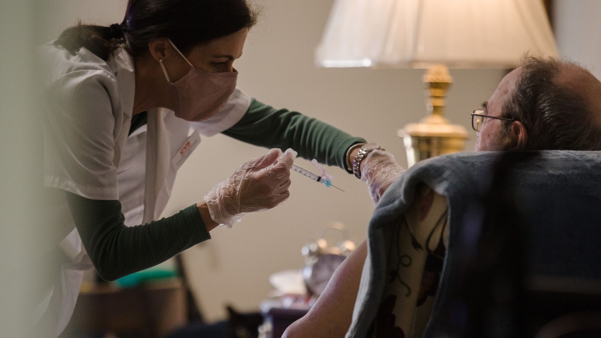 A healthcare worker giving a patient a dose of coronavirus vaccine in an assisted living home in Sumter, South Carolina, on Jan. 26.