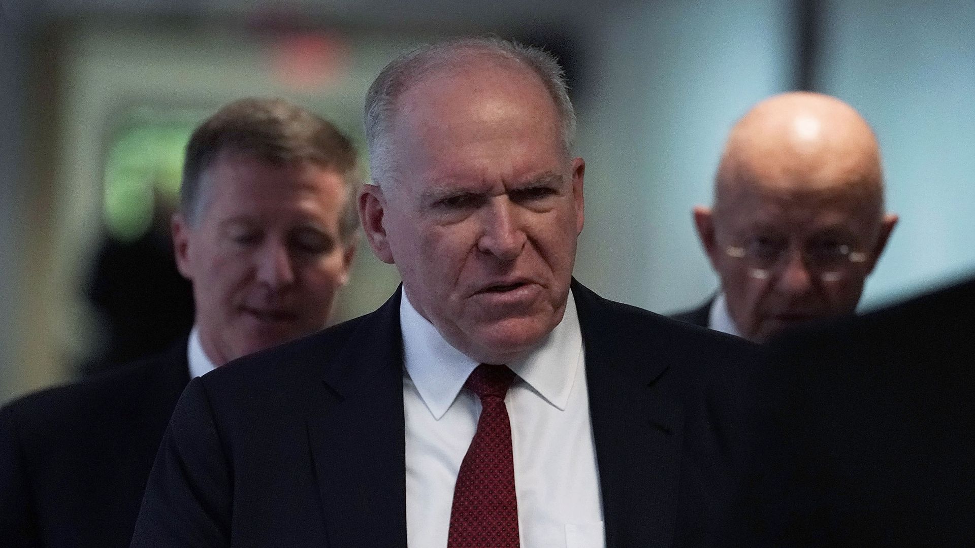John Brennan walks with James Clapper at a hearing before the Senate Intelligence Committee.