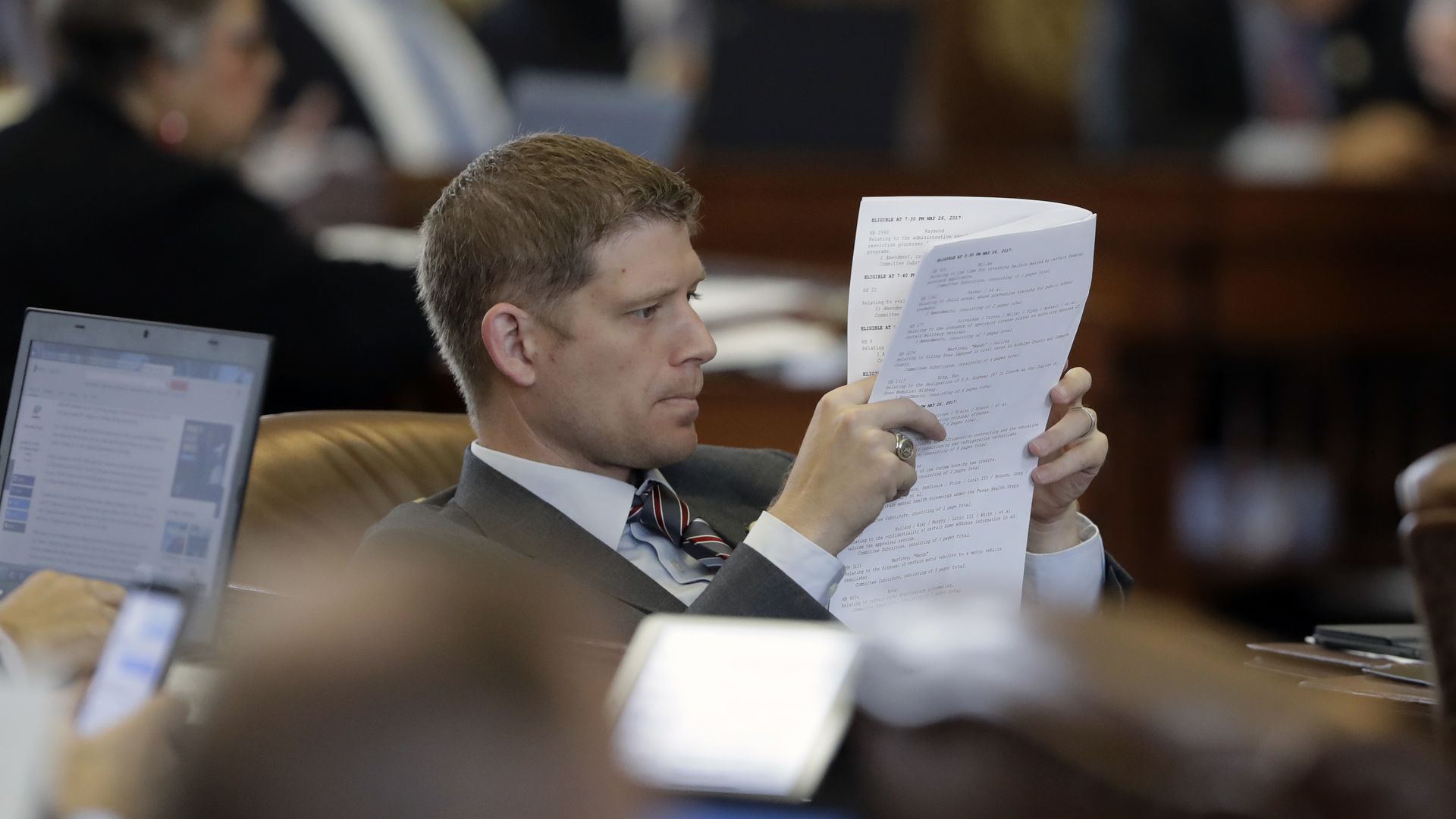 A legislator reading a document