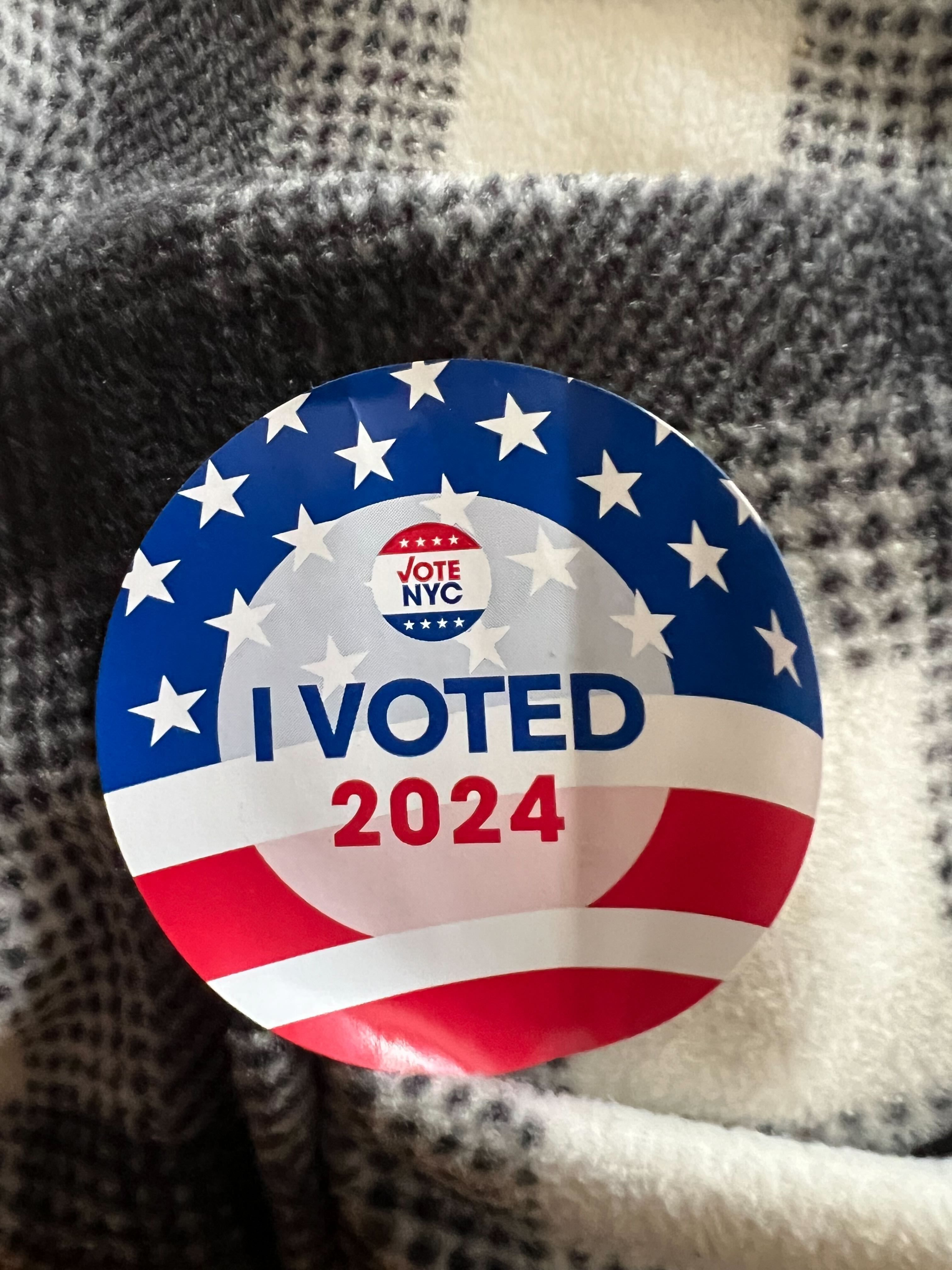 Photo shows an "I voted" sticker.