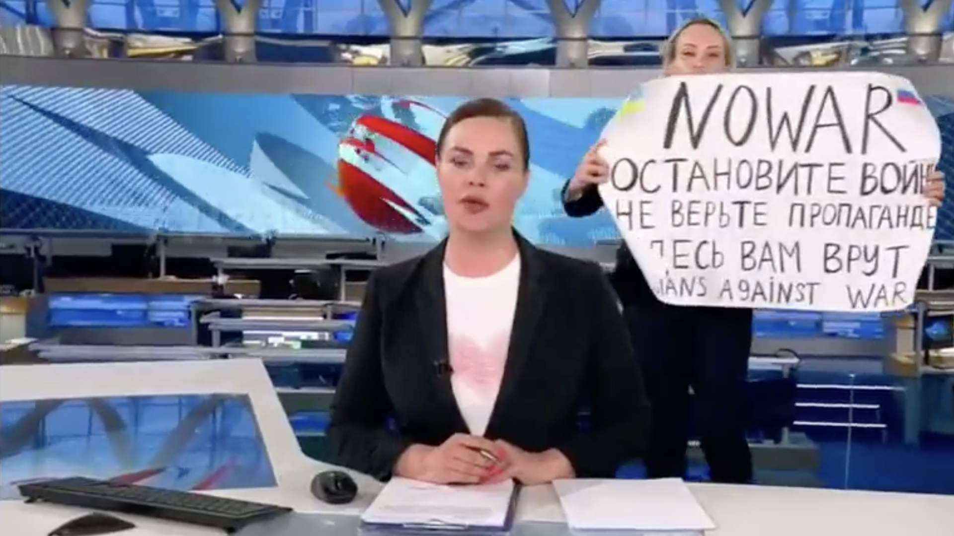 Woman interrupts Russian newscast with sign that reads "No war"