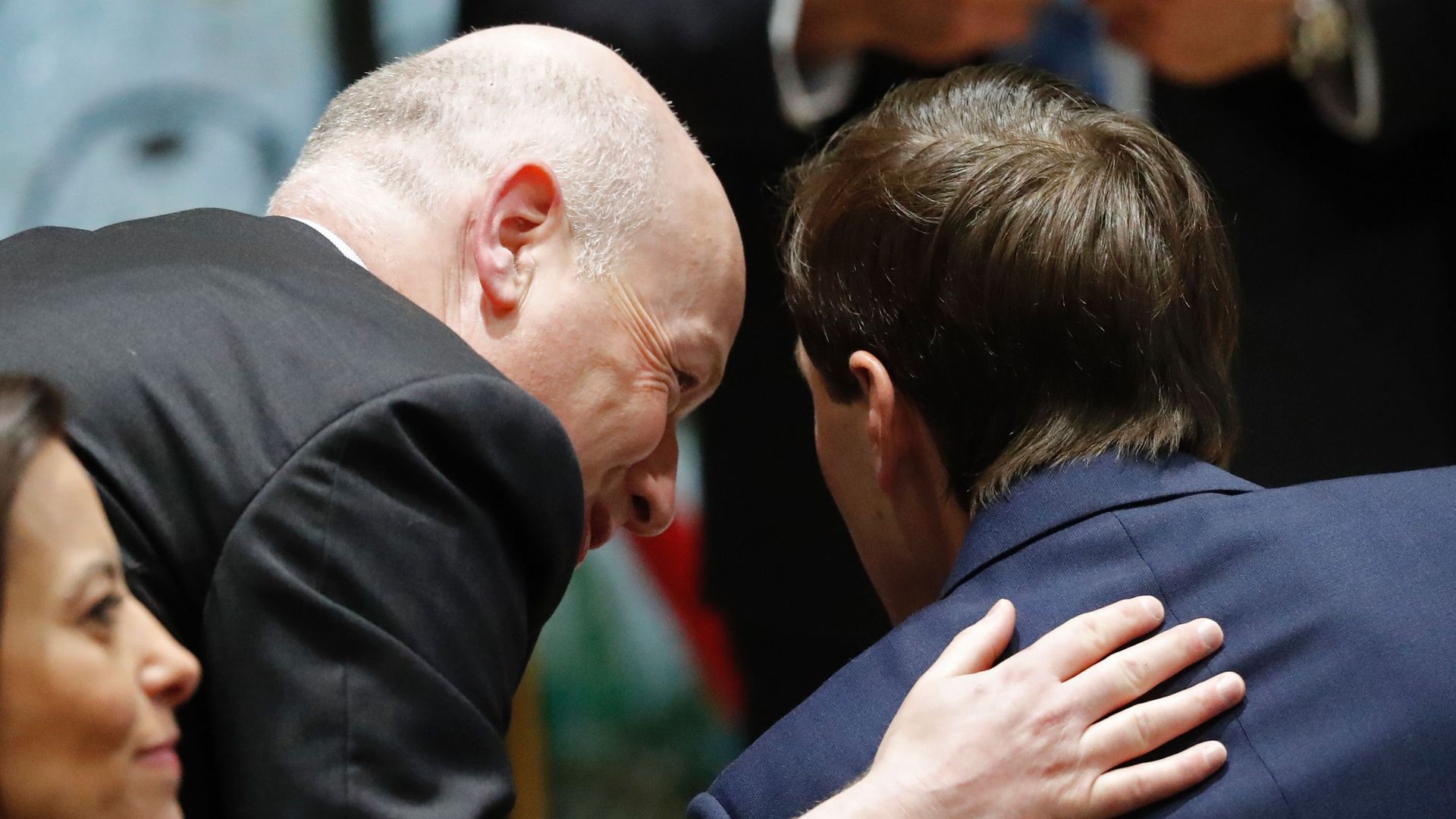 Jason Greenblatt leans over to speak in Jared Kushner's ear.