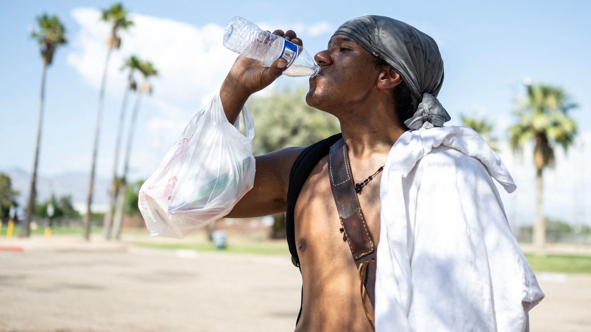 A man drinking a bottle of water. 