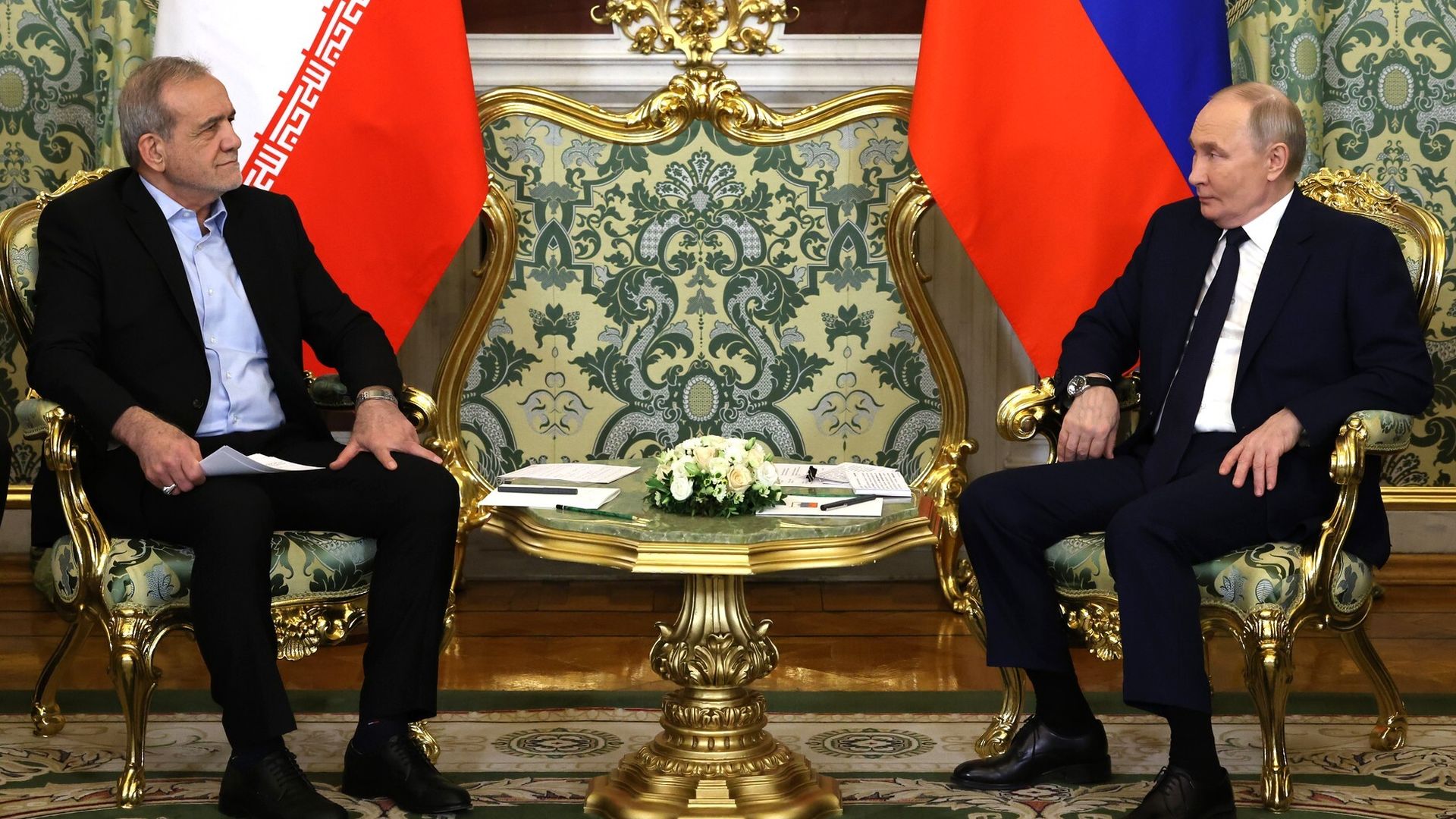 Two guys in chairs with flags