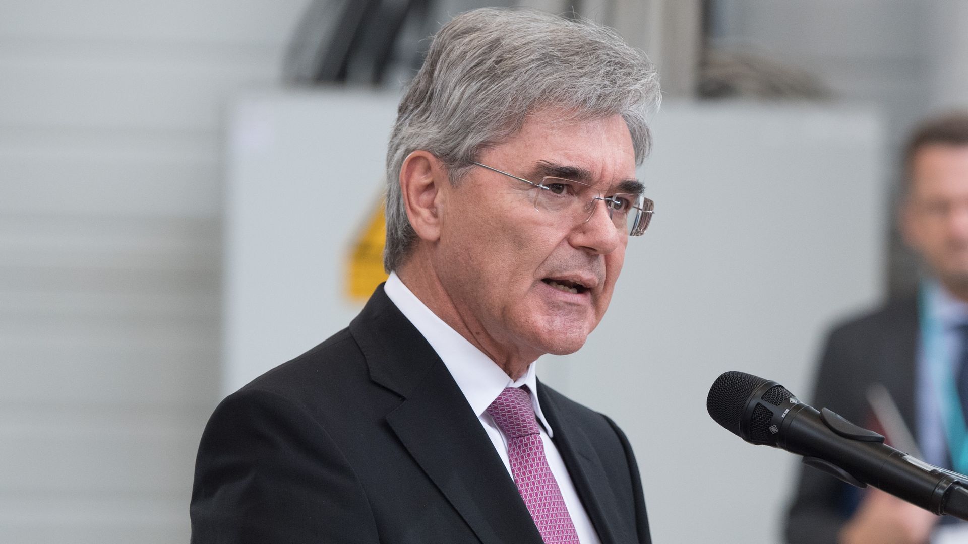 Siemens CEO speaking into a microphone.