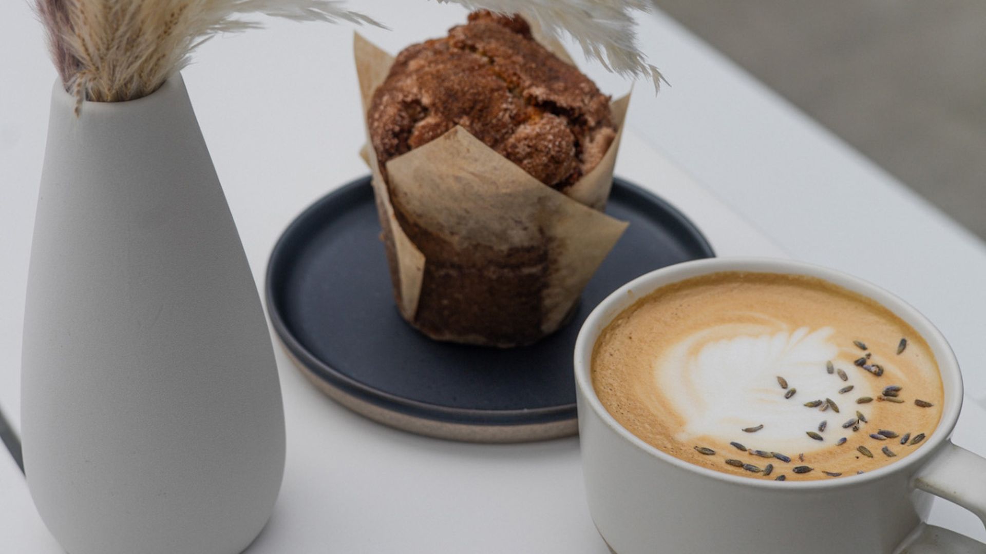 A coffee cup and a muffin