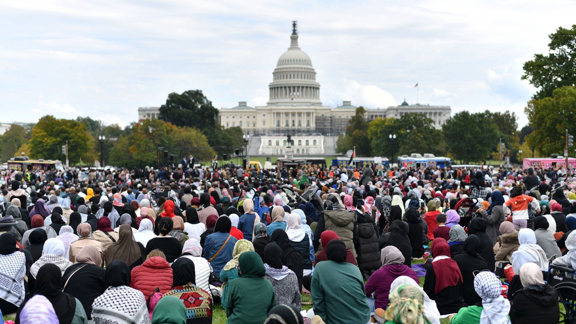 Hundreds of Muslim women sit in the back, behind Muslim men, during a peace prayer at the National Mall 