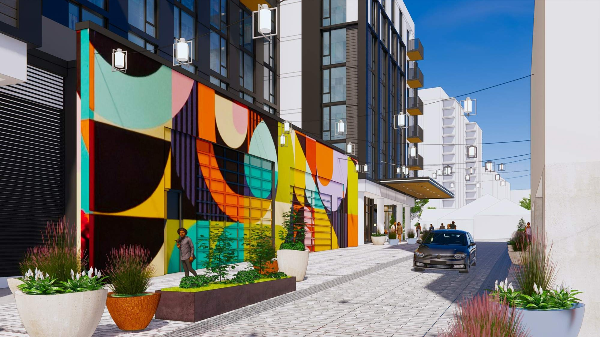 Urban street with modern buildings, featuring a vibrant geometric mural in yellow, orange, blue, and black. Potted plants line the sidewalk with people walking and a black car parked.