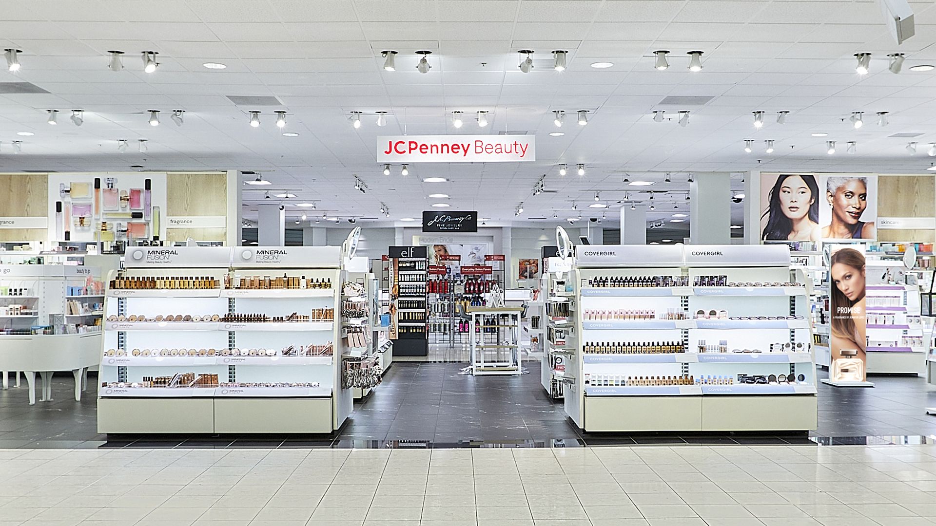 Department store JCPenney's new beauty section in its stores includes bright lighting and white fixtures under a sign that says JCPenney Beauty, spelled out in red lettering.