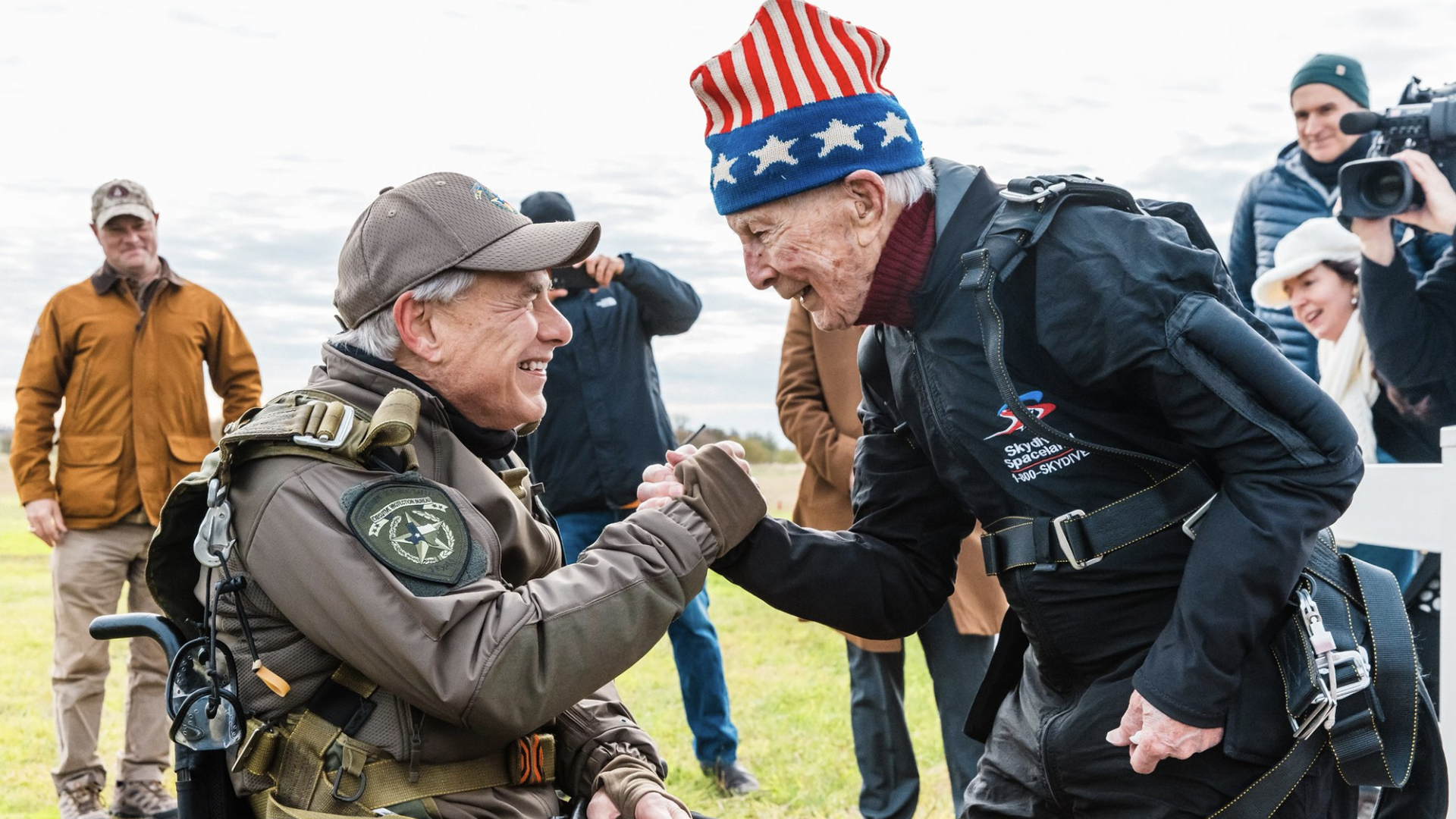 Gov. Greg Abbott and a World II veteran share a handshake.