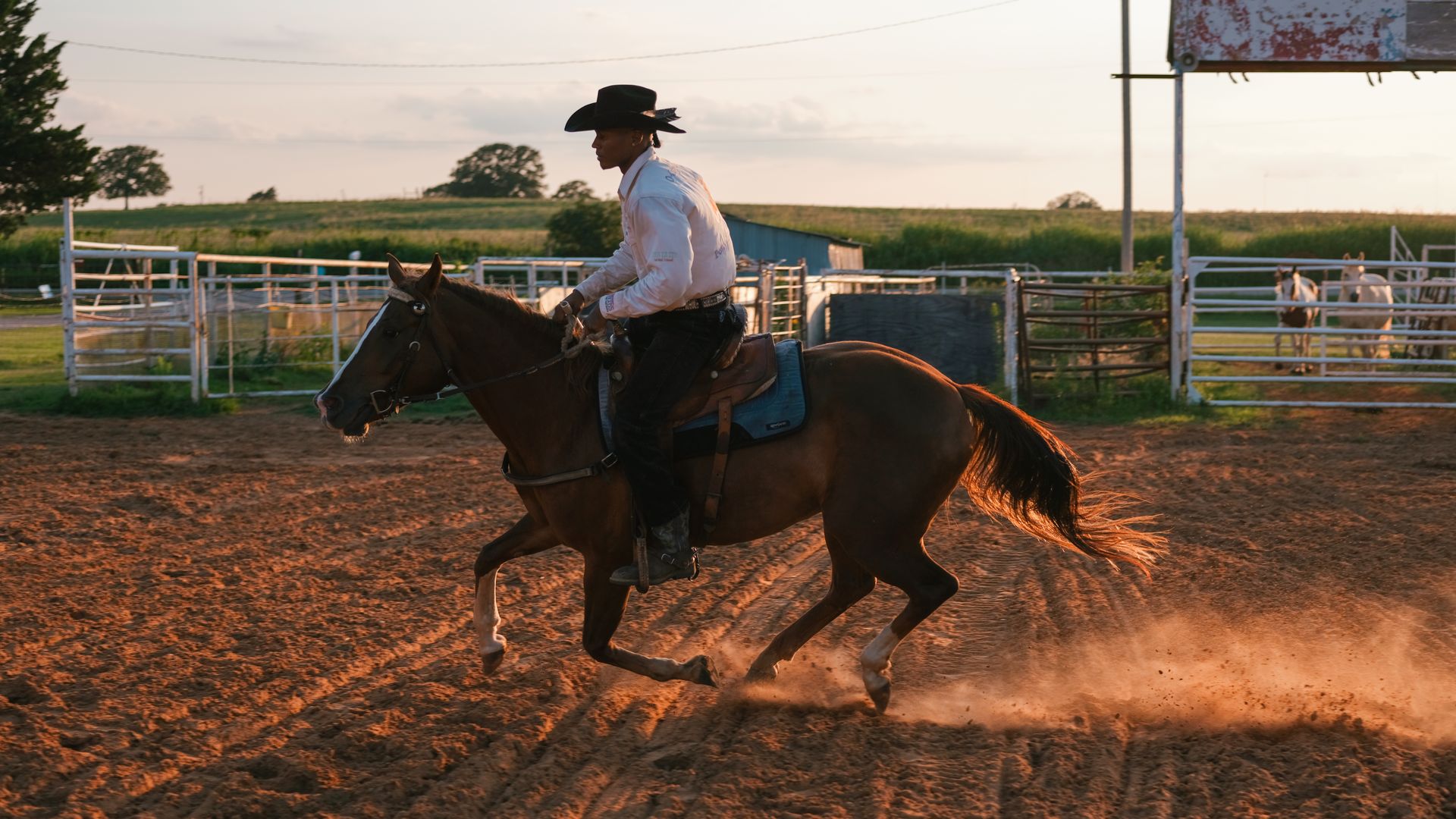 Photo of a Black man riding on a galloping horse.