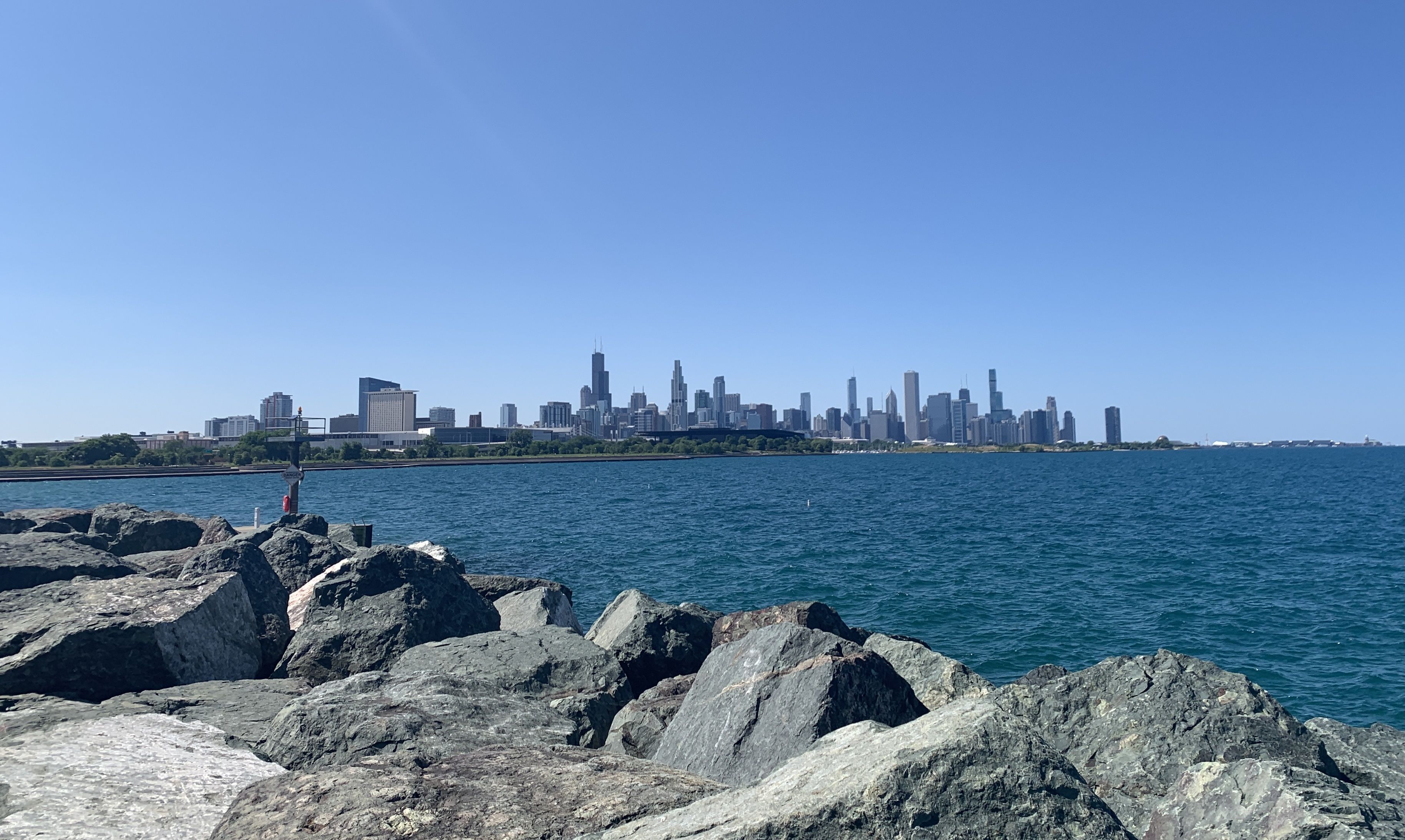 Photo of a skyline in the distance with a lake in front of it. 