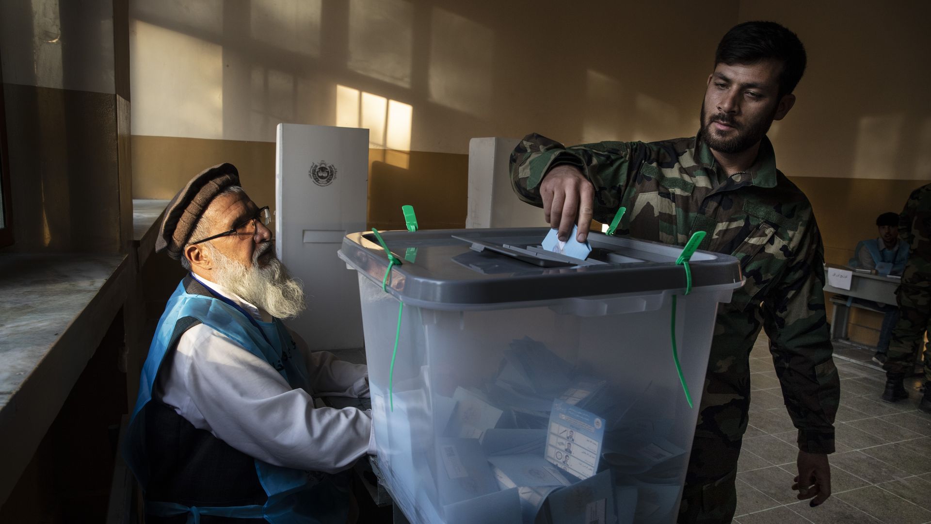 Afghan soldier submits his vote at a polling place