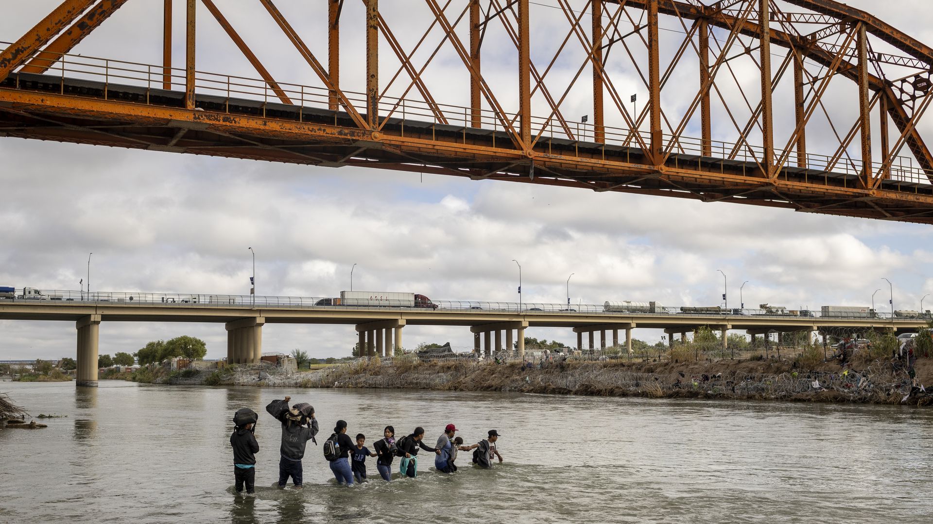 Asylum seekers cross the Rio Grande from Mexico into the United States 