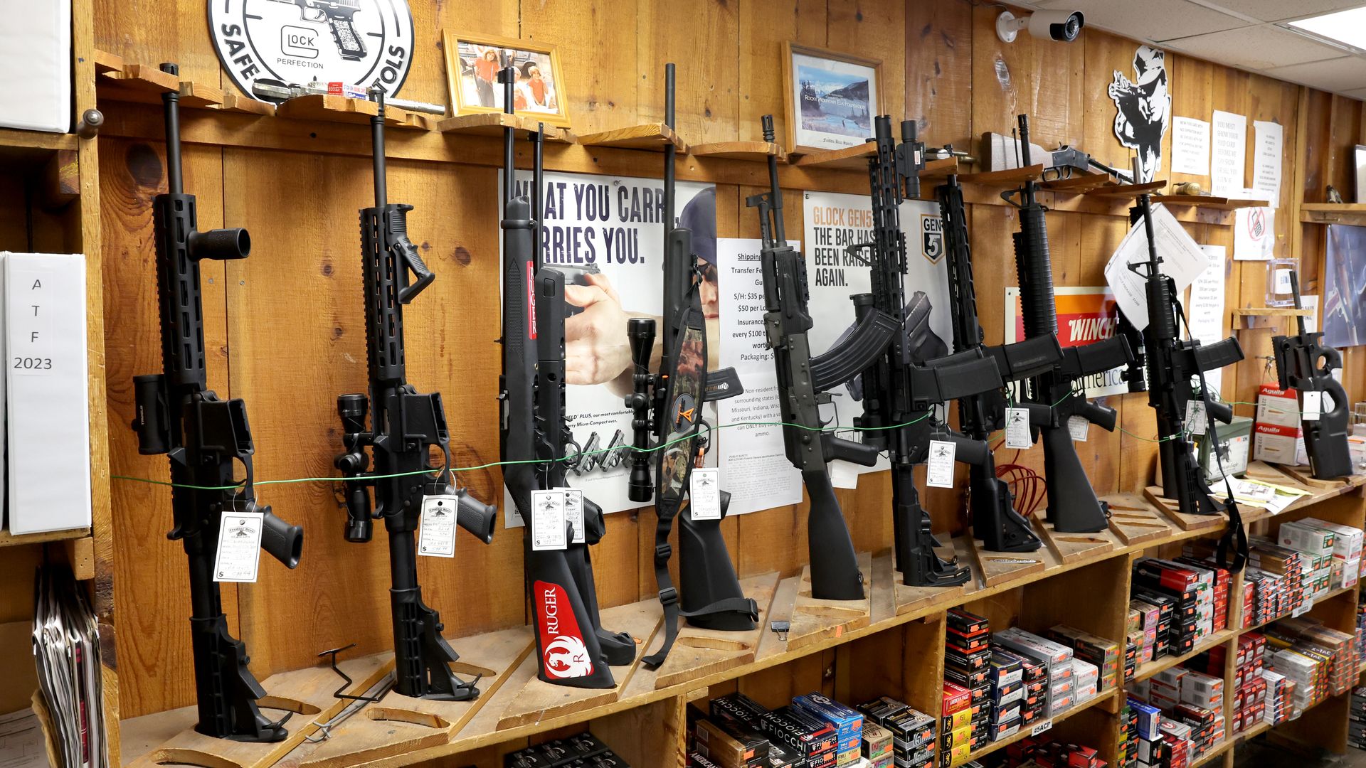 Photo of a bunch of rifles on display in a store. 