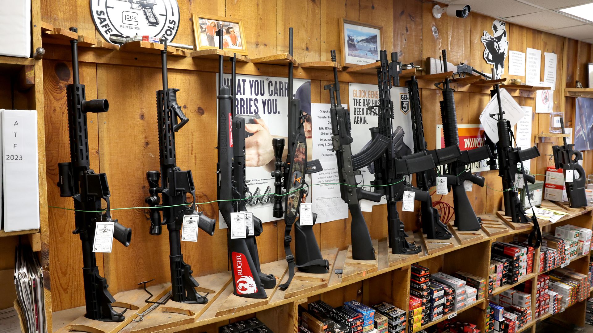 Photo of a bunch of rifles on display in a store.