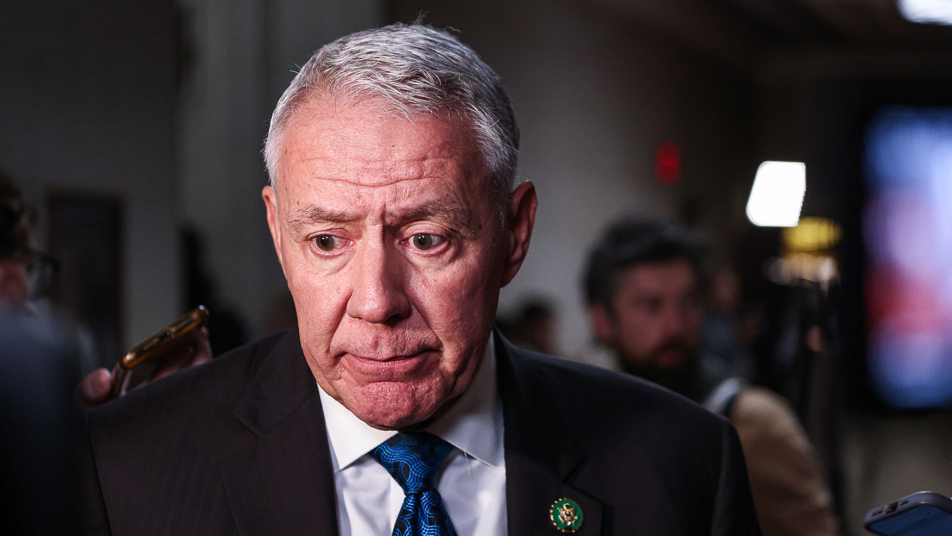 Rep. Ken Buck, wearing a dark gray suit, white shirt and dark blue tie.