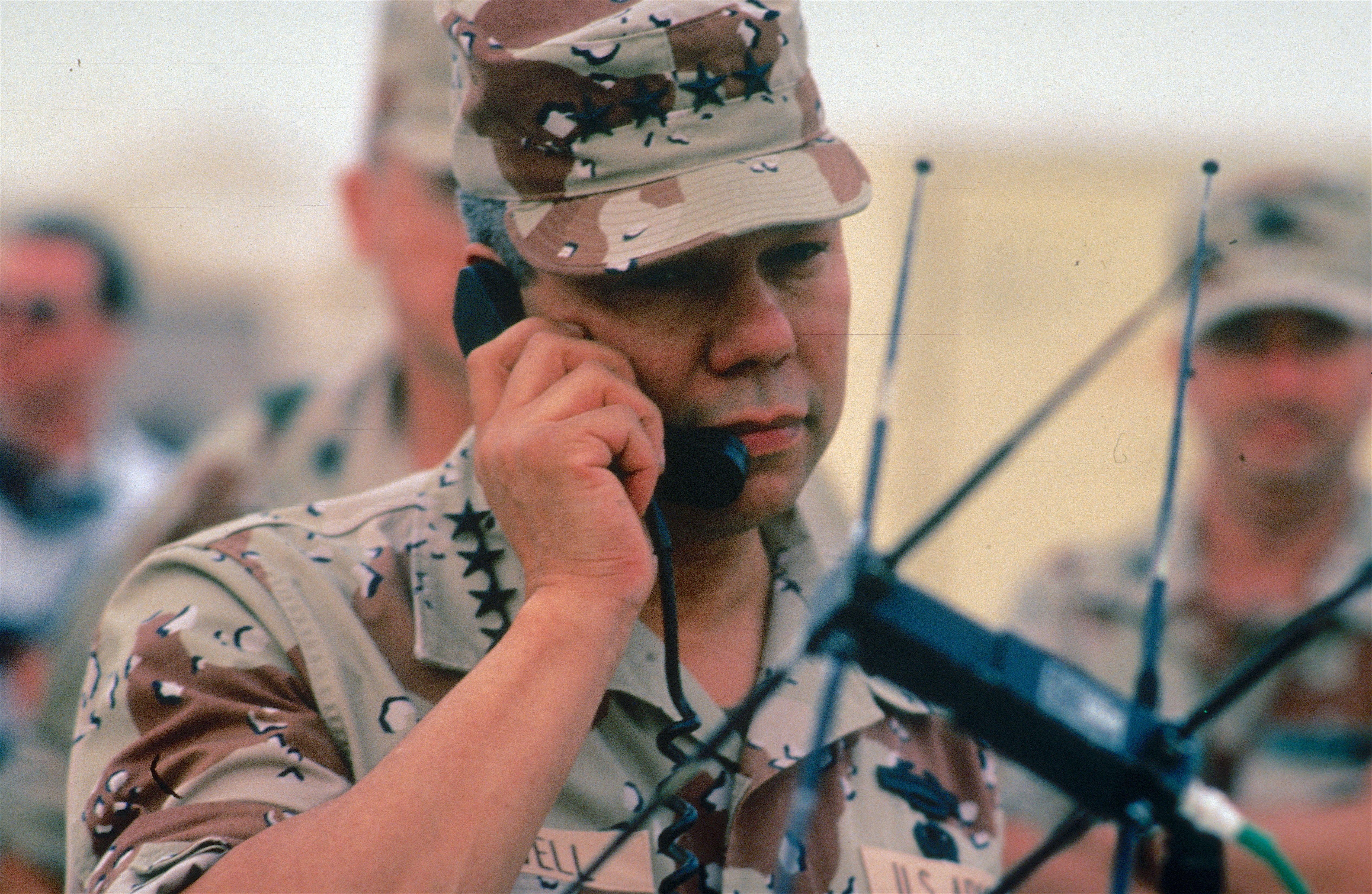 Then Chairman of the Joint Chiefs of Staff General Colin Powell on a phone visit with troops in Saudi Arabia. 