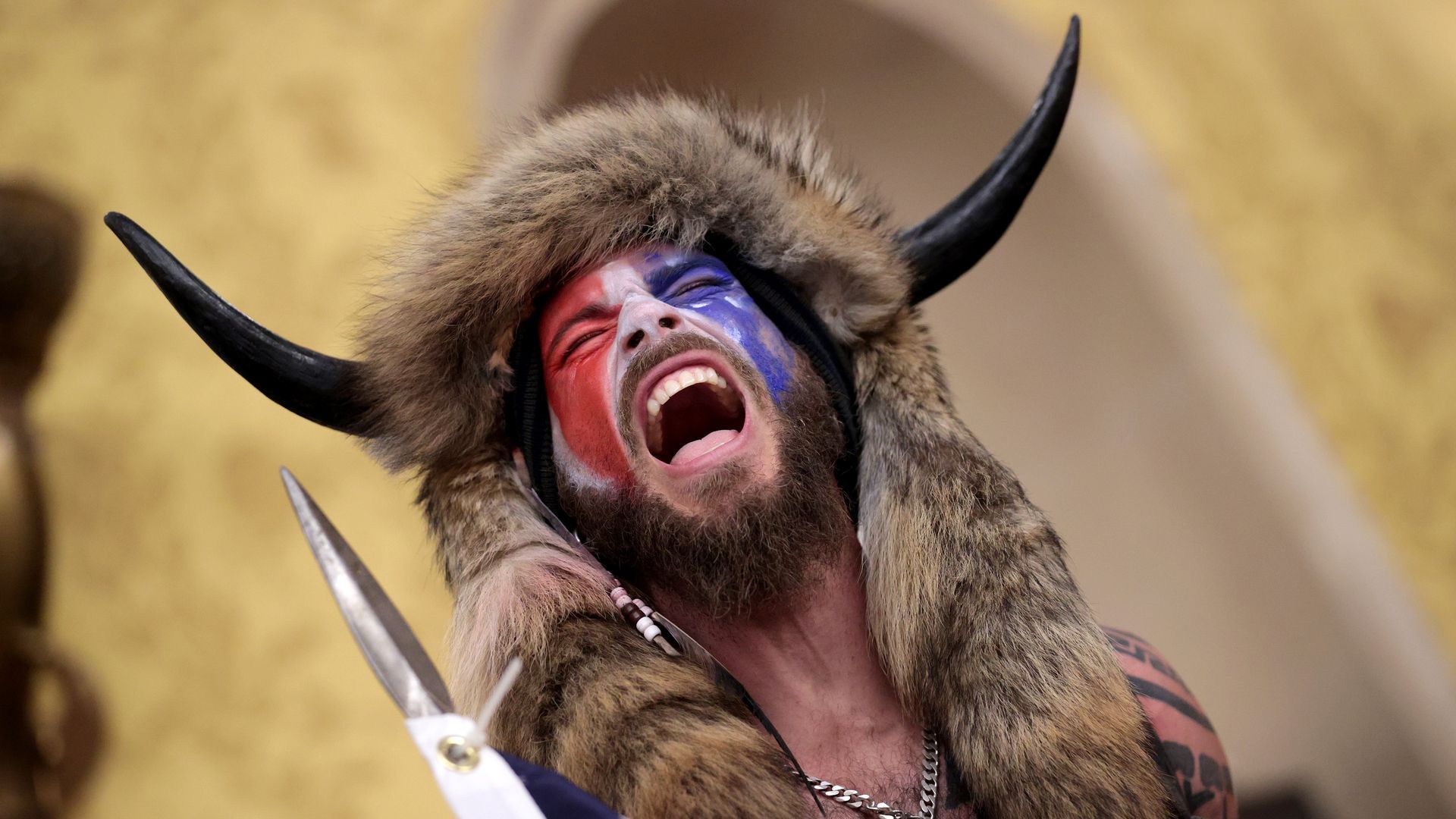 One of the rioters at the U.S. Capitol dressed in fur, some horns and with red, white and blue face paint.
