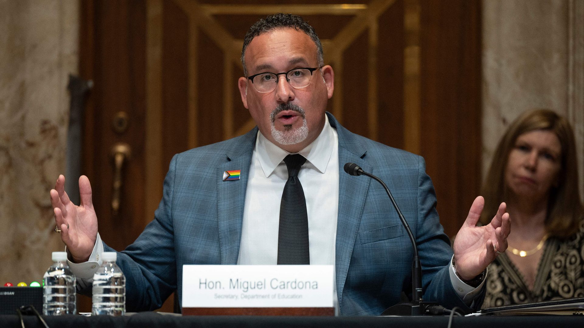 Education Secretary Miguel Cardona is seen speaking during a congressional hearing.