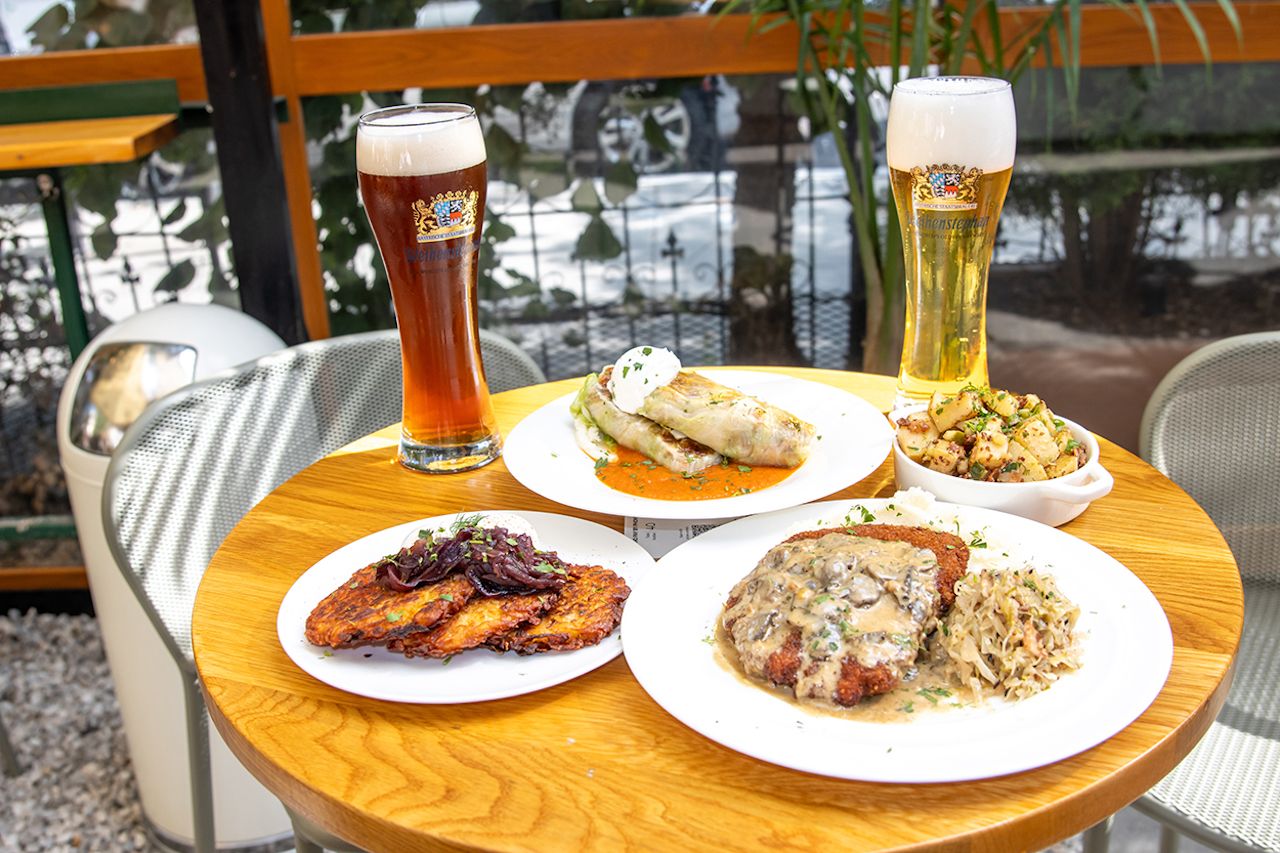 German food and beer on a table at Dacha 