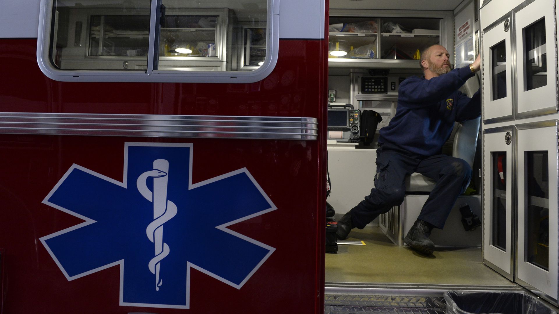 A paramedic prepares an ambulance for upcoming calls.