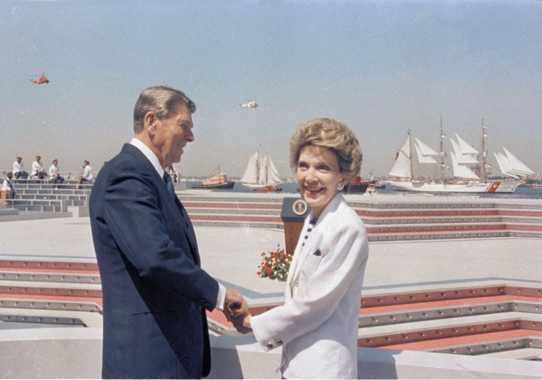Nancy and Ronald Raegan holding hands. 