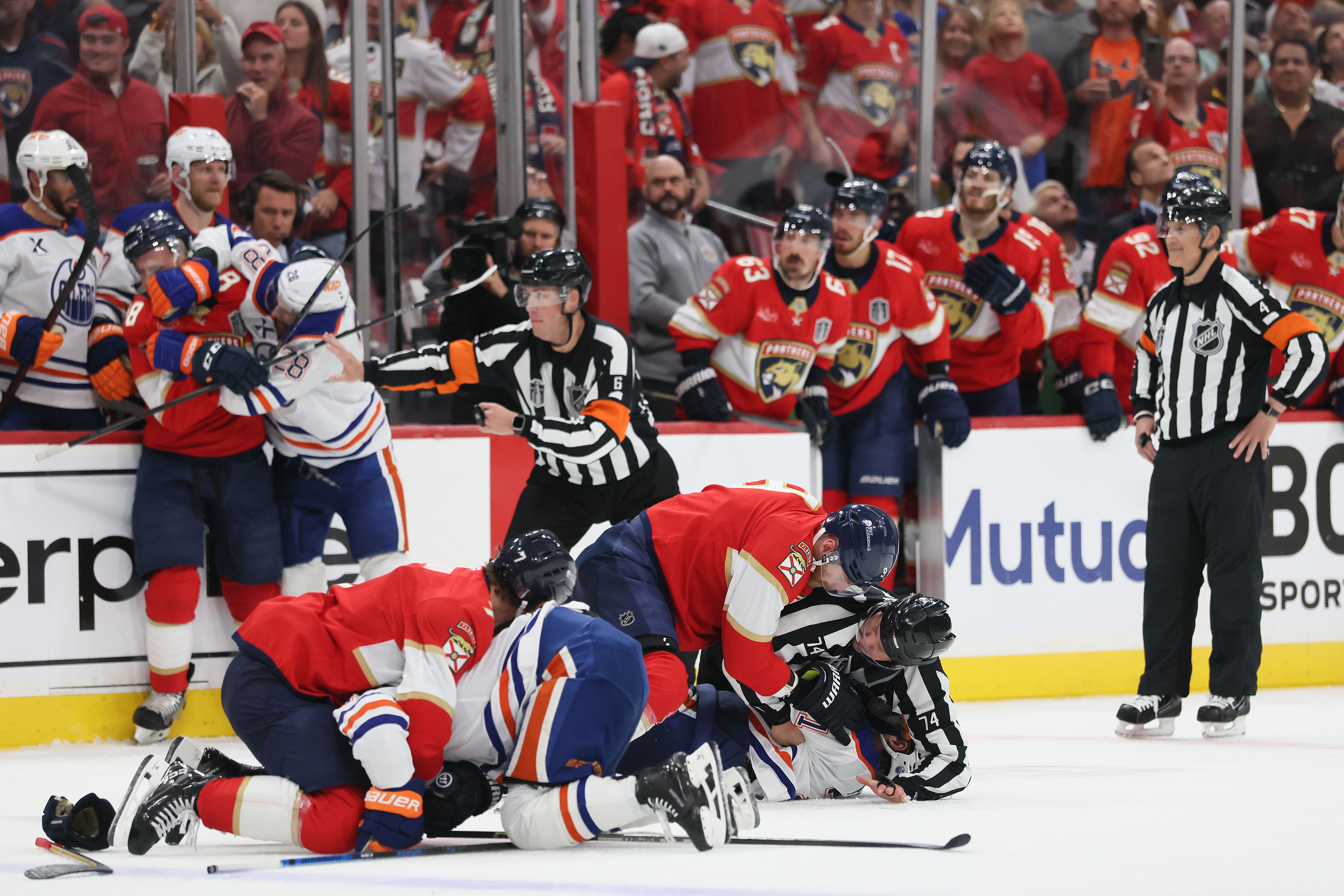 SUNRISE, FLORIDA - JUNE 09: Game officials attempt to break up a fight between the Edmonton Oilers and the Florida Panthers during the third period in Game Three of the 2025 Stanley Cup Final at Amerant Bank Arena on June 09, 2025 in Sunrise, Florida. (Photo by Bruce Bennett/Getty Images)