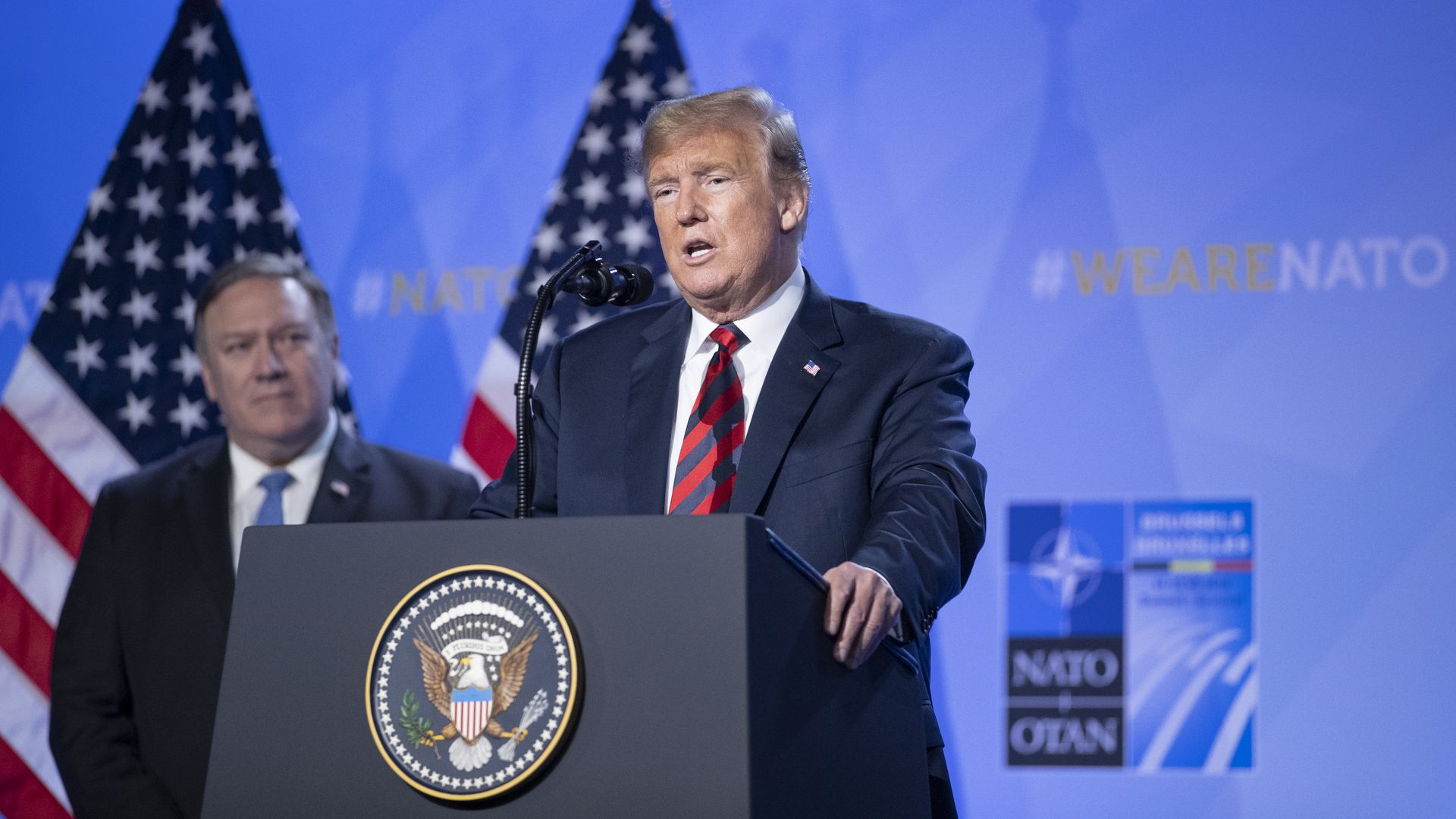 President Donald Trump speaks besides U.S. Secretary of State Mike Pompeo during a news conference at the 2018 NATO Summit.