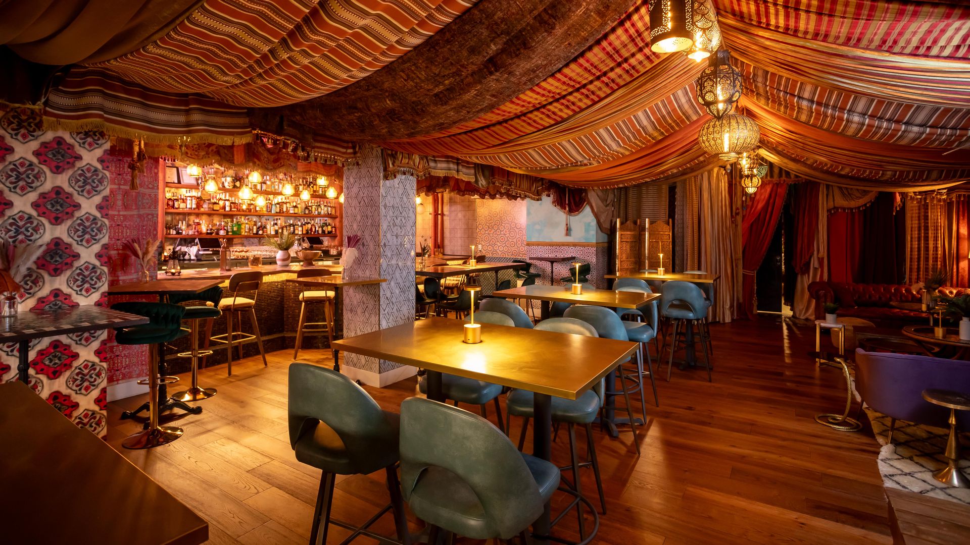 A fabric-lined Mediterranean cocktail lounge hung with lanterns