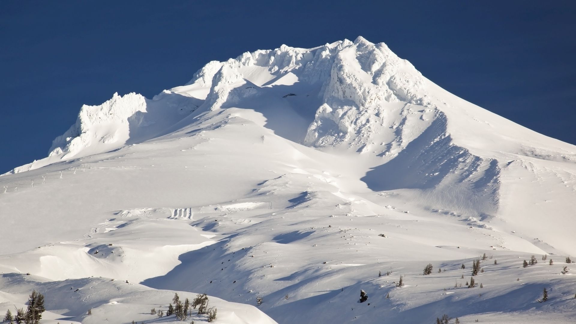 The top of Mount hood is seen covered in snow.