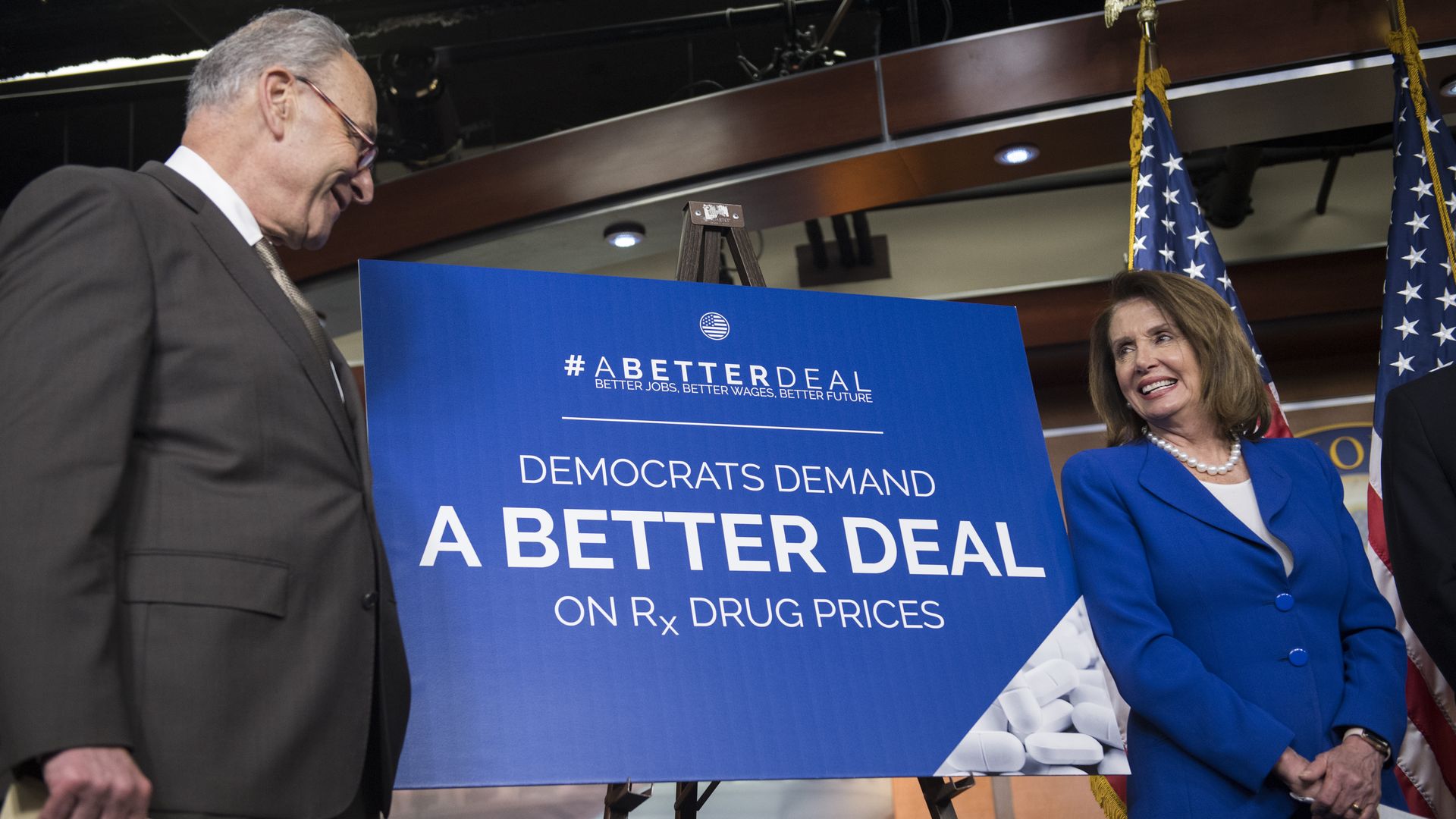 Schumer and Pelosi next to a drug price sign
