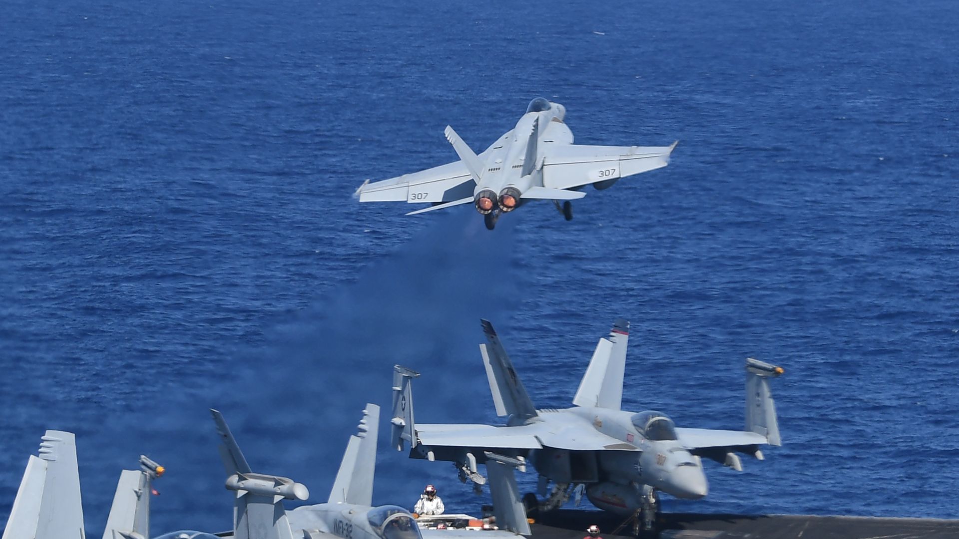F18 fighter jet takes off from aircraft carrier